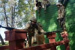Warrant Officer Candidate Kristina Howgate of Indianapolis, Indiana, negotiates an obstacle course during phase three of Warrant Officer Candidate School at Camp Atterbury, Indiana, Sept. 16, 2019.