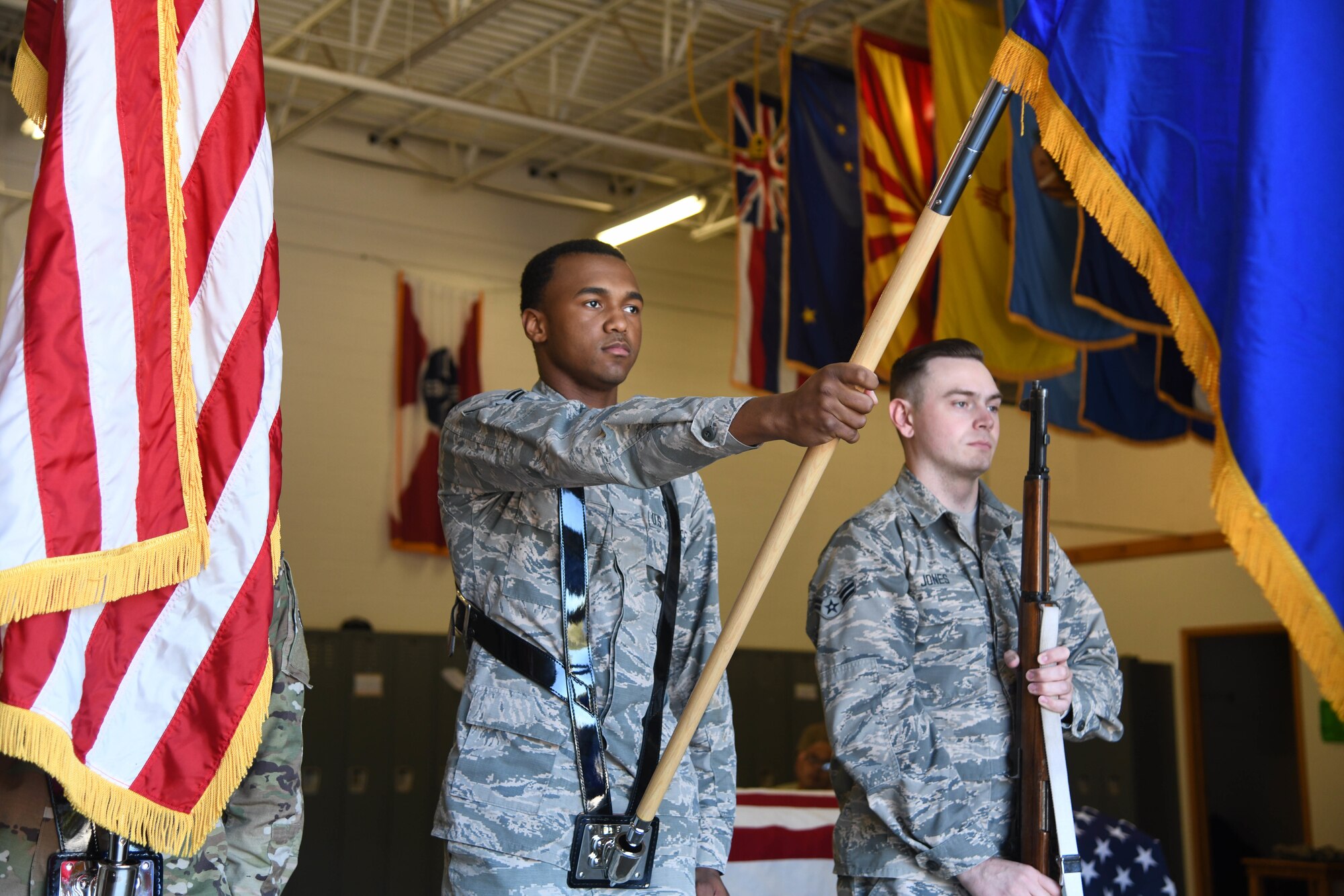 Airman 1st Class Darrell Mills, 22nd Civil Engineering Squadron water and fuels system maintenance craftsman and Nicholas Jones, 22nd Maintenance Squadron aircraft structural maintenance journeyman, present the colors during honor guard training Oct. 8, 2019, at McConnell Air Force Base, Kan. McConnell’s Base Honor Guard trains five days a week to prepare for duties such as change of command ceremonies, community events, military retirements and funerals. (U.S. Air Force photo by Airman 1st Class Nilsa E. Garcia)