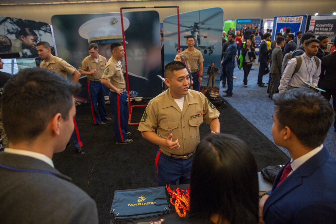 Staff Sgt. Alexander Tran, a Cyberspace Exploitation Operator with Marine Forces Cyber Command, discusses opportunities in the Marine Corps with attendees of the Society of Asian Scientists and Engineers (SASE) National Conference career fair in Pittsburgh, Pennsylvania, October 12, 2019. SASE consists of more than 100 college chapters and was founded to give engineering students of Pan-Asian decent an opportunity to achieve their full potential while connecting and supporting one another. The presence of Marines at the SASE National Conference creates a reminder that Marines are supportive of the organization, its efforts and the communities it represents. (U.S. Marine Corps photo by Lance Cpl. Mitchell Collyer)