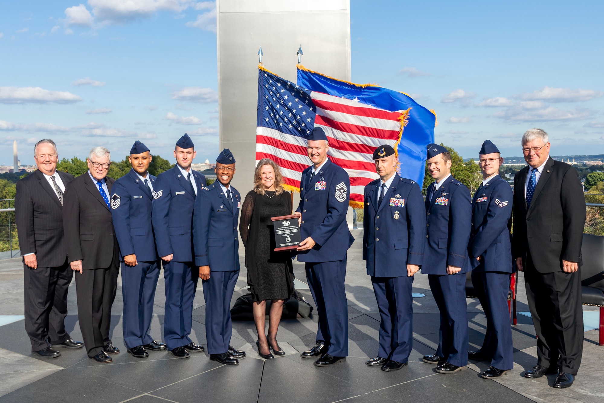 Col. Gavin Marks, 55th Wing commander, Chief Master Sgt. Brian Thomas, 55th Wing command chief, and five other wing members accept the award from Jonna Doolittle, granddaughter of James Doolittle, at the Air Force Memorial in Arlington, Virginia Oct. 9, 2019.