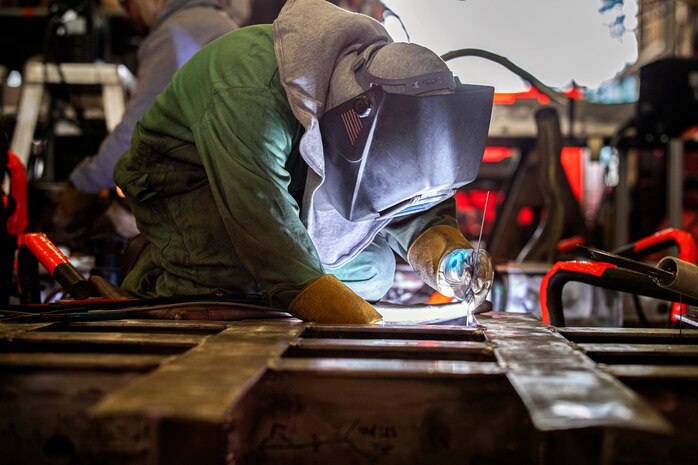 Tran Anderson, Shop 26, Welders, works on a cofferdam Sept. 18, 2019, inside Building 460.