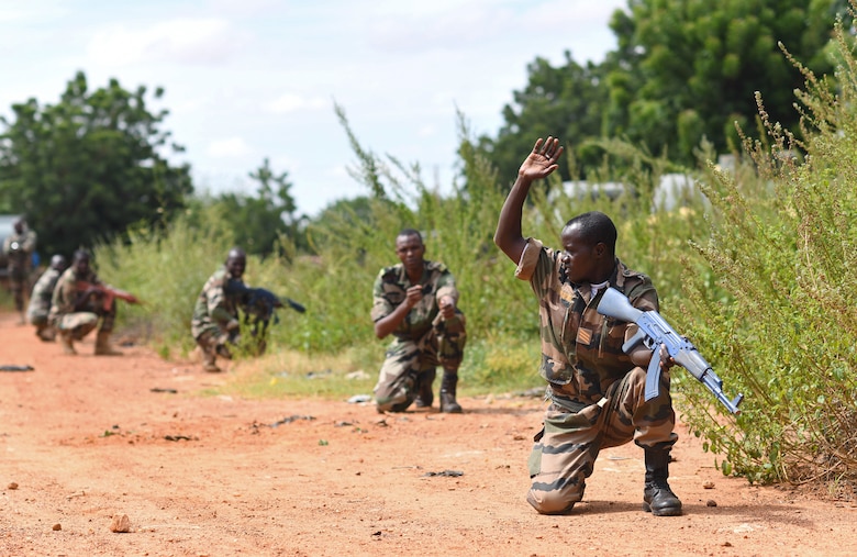 Forces Armées Nigeriennes (Nigerien Armed Forces) Genie Unit members crouch, alert to a simulated threat during an Improvised Explosive Device Awareness Course in Niamey, Niger, Oct. 11, 2019. During the week-long course, the 768th Expeditionary Air Base Squadron Explosive Ordnance Disposal team and Security Forces Air Advisors taught FAN personnel valuable skills for the deployed environment such as how to locate and react to an IED, how set up a cordon and the procedures to clear the area. (U.S. Air Force photo by Staff Sgt. Alex Fox Echols III)
