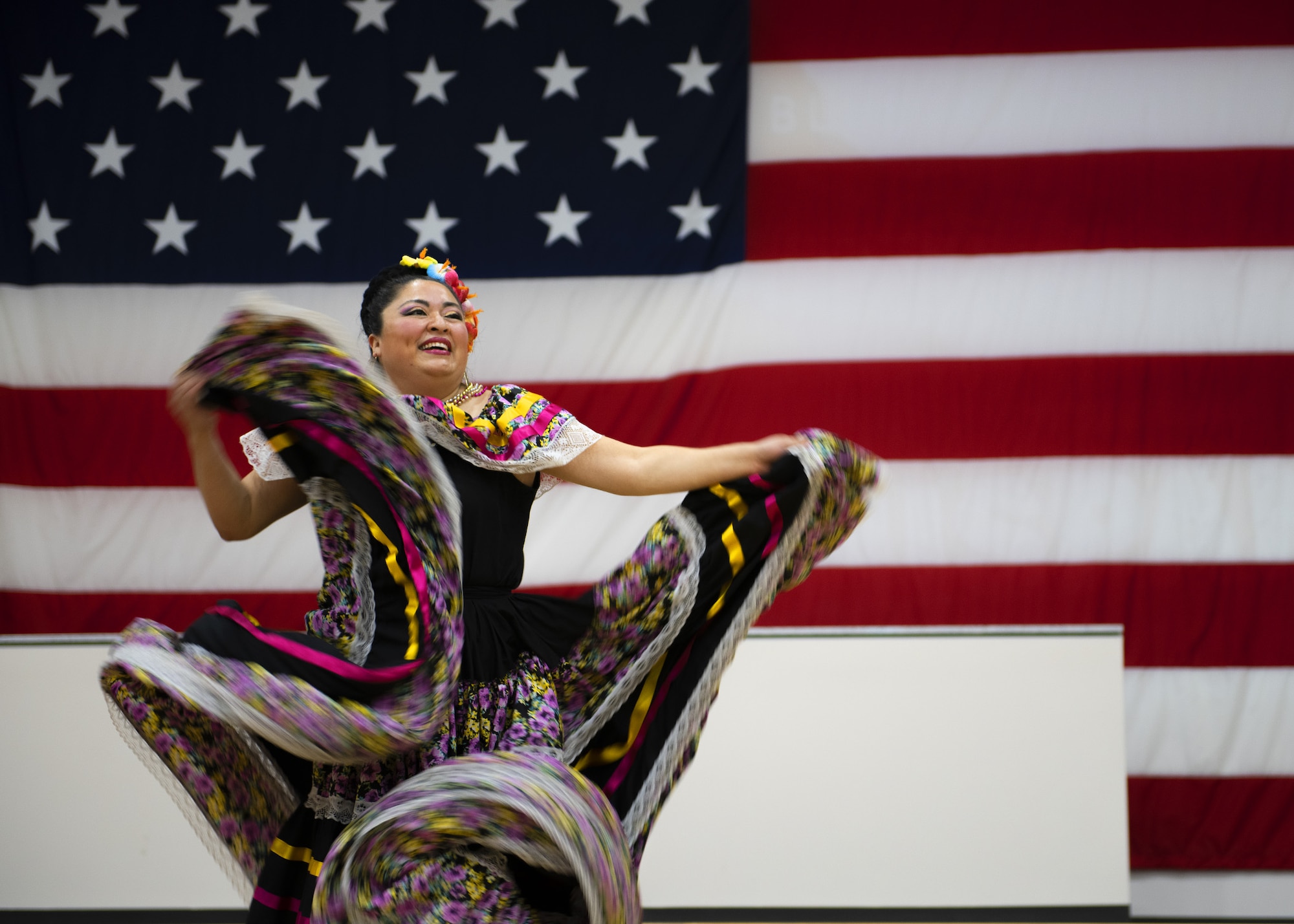 A member of the Ollin Yoliztli Mexican Folklore Dance Academy performs a traditional dance during the Hispanic Heritage Month closing ceremony at the Navy Operational Support Center, Oct. 15, 2019, at Luke Air Force Base, Ariz.
