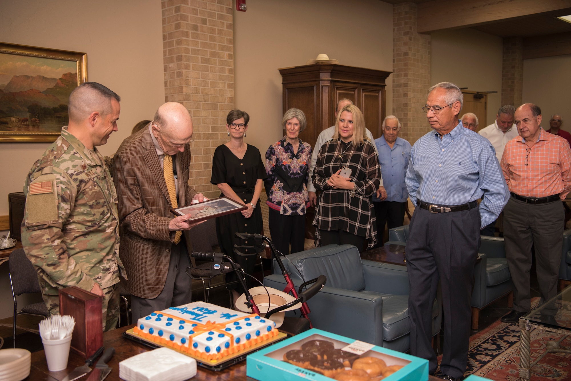 Members gather to celebrate Bill Cauthorn’s, lifetime honorary commander and CEO of The Bank and Trust, recognition from Col. Lee Gentile, 47th Flying Training Wing commander, in Del Rio, Texas, Oct. 15, 2019. Cauthorn received a custom belt buckle as a gift for his lifelong commitment to Laughlin Air Force Base. (U.S. Air Force photo by Senior Airman Marco A. Gomez)
