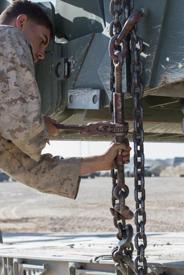 U.S. Marine Corps Lance Cpl. Brandon Cree, a heavy equipment operator with Third Battalion, Second Marines, Second Marine Division (2d MARDIV) secures faulty equipment to a trailer on Camp Wilson, Marine Air Ground Combat Center, Twentynine Palms, California, Oct. 14, 2019. Marines with Third Battalion, Second Marines are preparing to support 2d MARDIV’s execution of MAGTF Warfighting Exercise 1-20 (MWX), from mid-October to early November. MWX is set to be the largest operation conducted by the division in several decades. (U.S. Marine Corps photo by Sgt. Stormy Mendez)
