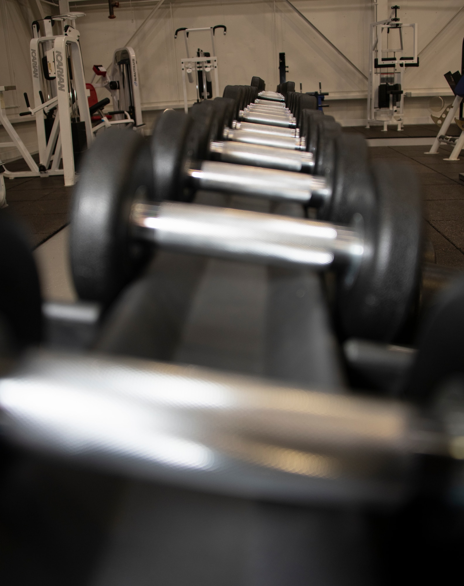 Dumbells sit on a rack in the Nose Dock Gym Oct. 11. 2019 at Travis Air Force Base, California. The new gym at Building 844 was facilitated through existing base funds, equipment donations and volunteer work by the 60th Mission Support Group. (U.S. Air Force photo by Heide Couch)