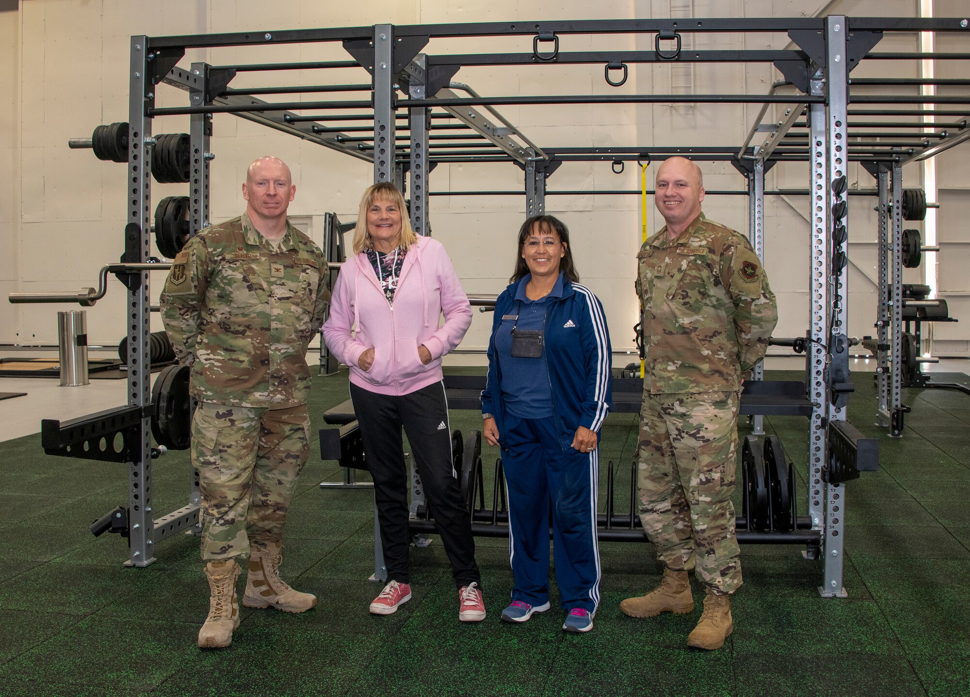 From left to right, U.S. Air Force Col. Victor Beeler, 60th Mission Support Group, commander, Barbara Green, programs director, and Tanya McCormick, fitness and sports director, both with the 60th Force Support Squadron and Chief Master Sgt. Matthew Pulsipher, 60th MSG interim superintendent, stand inside the Nose Dock Gym Oct. 11, 2019, at Travis Air Force Base, California. The new gym at Building 844 was facilitated through existing base funds, equipment donations and volunteer work by the 60th Mission Support Group. (U.S. Air Force photo by Heide Couch)