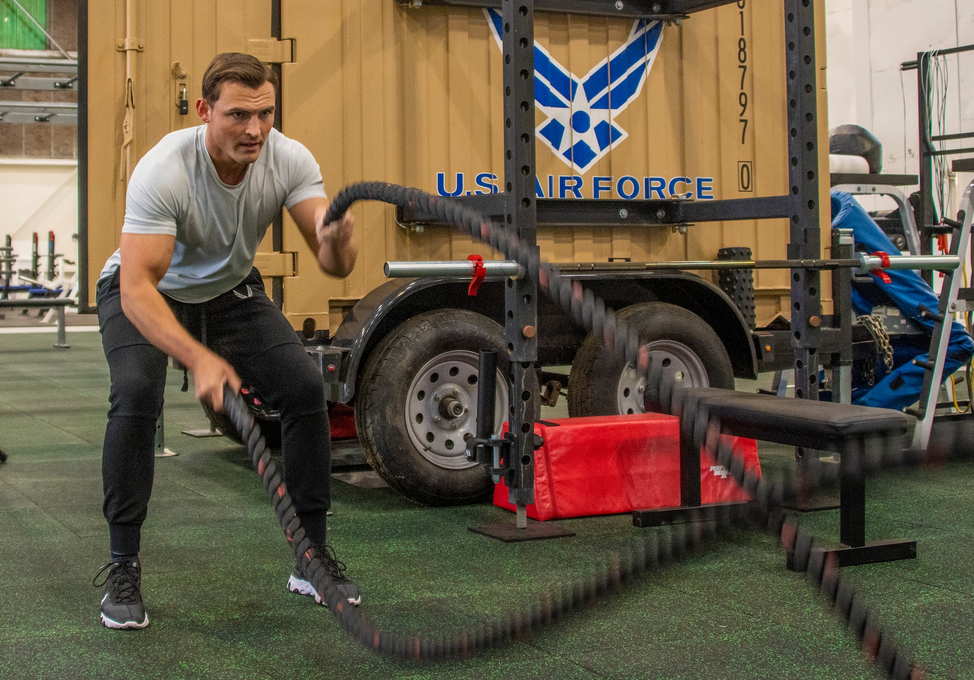 U.S. Air Force Senior Airman Joshua Knutson, 60th Force Support Squadron fitness specialist, performs a battle rope work out in the Nose Dock Gym Oct 11, 2019, at Travis Air Force Base, California. The new gym at Building 844 was facilitated through existing base funds, equipment donations and volunteer work by the 60th Mission Support Group. (U.S. Air Force photo by Heide Couch