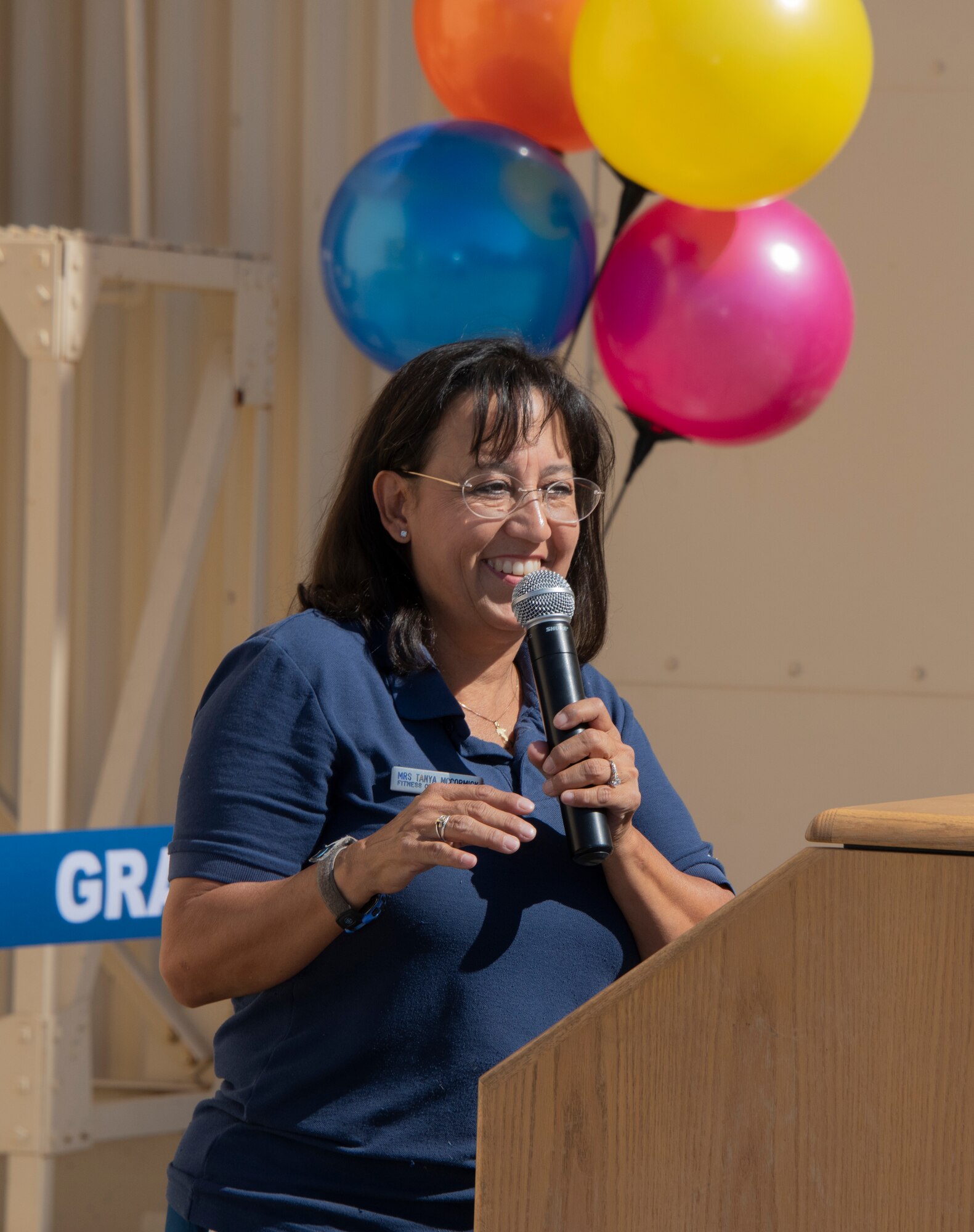 Tanya McCormick, 60th Force Support Squadron fitness and sports center manager, delivers her remarks during the ribbon cutting ceremony of the Nose Dock Gym Oct. 15, 2019, at Travis Air Force Base, California. The new gym at Building 844 was facilitated through existing base funds, equipment donations and volunteer work by the 60th Mission Support Group. (U.S. Air Force photo by Heide Couch)