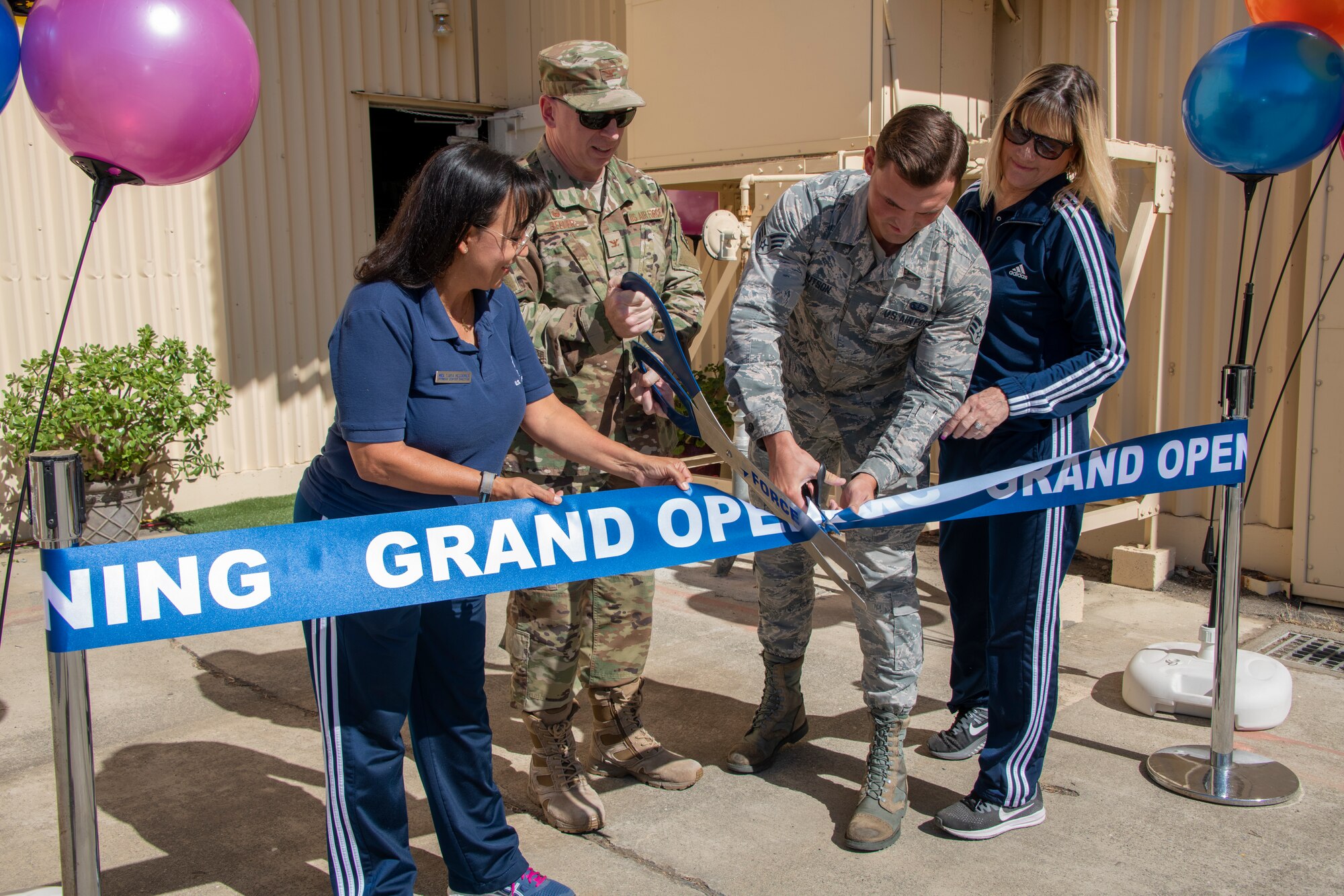 From left to right, Tanya McCormick, 60th Force Support Squadron fitness and sports center manager, U.S. Air Force Col. Victor Beeler, 60th Mission Support Group commander, Senior Airman Joshua Knutson, fitness specialist and Barbara Green, programs director both with the 60th FSS, cut the ribbon to open the Nose Dock Gym Oct. 15, at Travis Air Force Base, California. The new gym at Building 844 was facilitated through existing base funds, equipment donations and volunteer work by the 60th Mission Support Group. The new facility is located on Nose Dock Lane off Ragsdale and V Street. Current operating hours are 6 – 8 and 4–8 p.m., subject to change. (U.S. Air Force photo by Heide Couch)