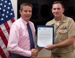 IMAGE: DAHLGREN, Va. (Sept. 19, 2019) - Naval Surface Warfare Center (NSWC) Dahlgren Division Commanding Officer Capt. Casey Plew presents Kris Parker with a letter of appreciation on behalf of NSWC Carderock Division Commanding Officer Capt. Cedric McNeal at an awards ceremony. Parker - the NSWC Dahlgren Division deputy for small business - was commended for serving as NSWC Carderock Division's acting deputy for small business for more than six months in 2019.