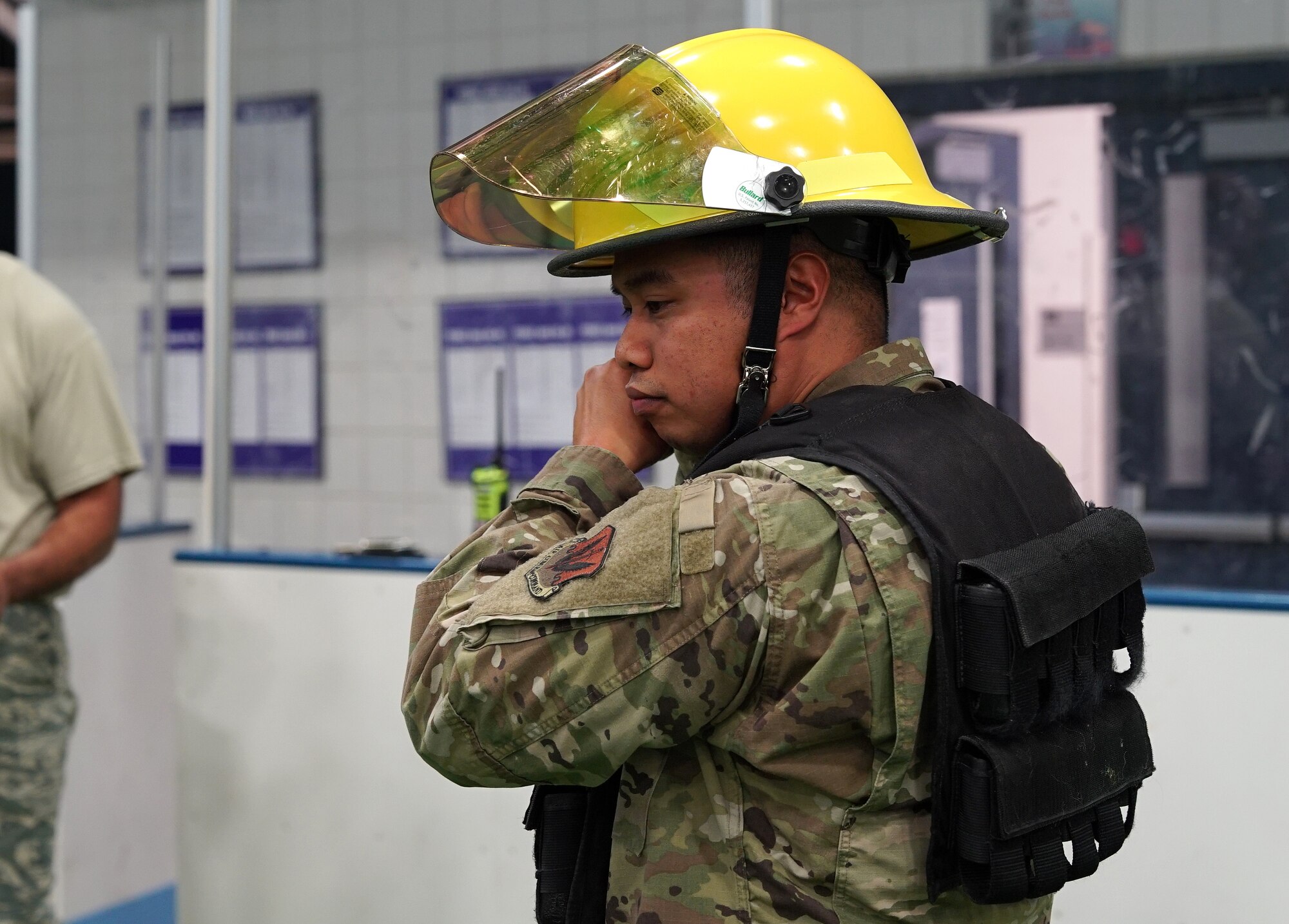 Tech. Sgt. Joseph Sanchez, 319th Operational Medical Readiness Squadron medical logistics flight chief, dons a firefighter helmet prior to participating in the base commander’s annual firefighter challenge Oct. 10, 2019, as part of National Fire Prevention Week on Grand Forks Air Force Base, North Dakota. Competitors also wore weighted vests for the event, which featured a variety of firefighting-themed strength challenges to include a tire flip, dummy drag and Jaws of Life carry. (U.S. Air Force photo by Senior Airman Elora J. Martinez)