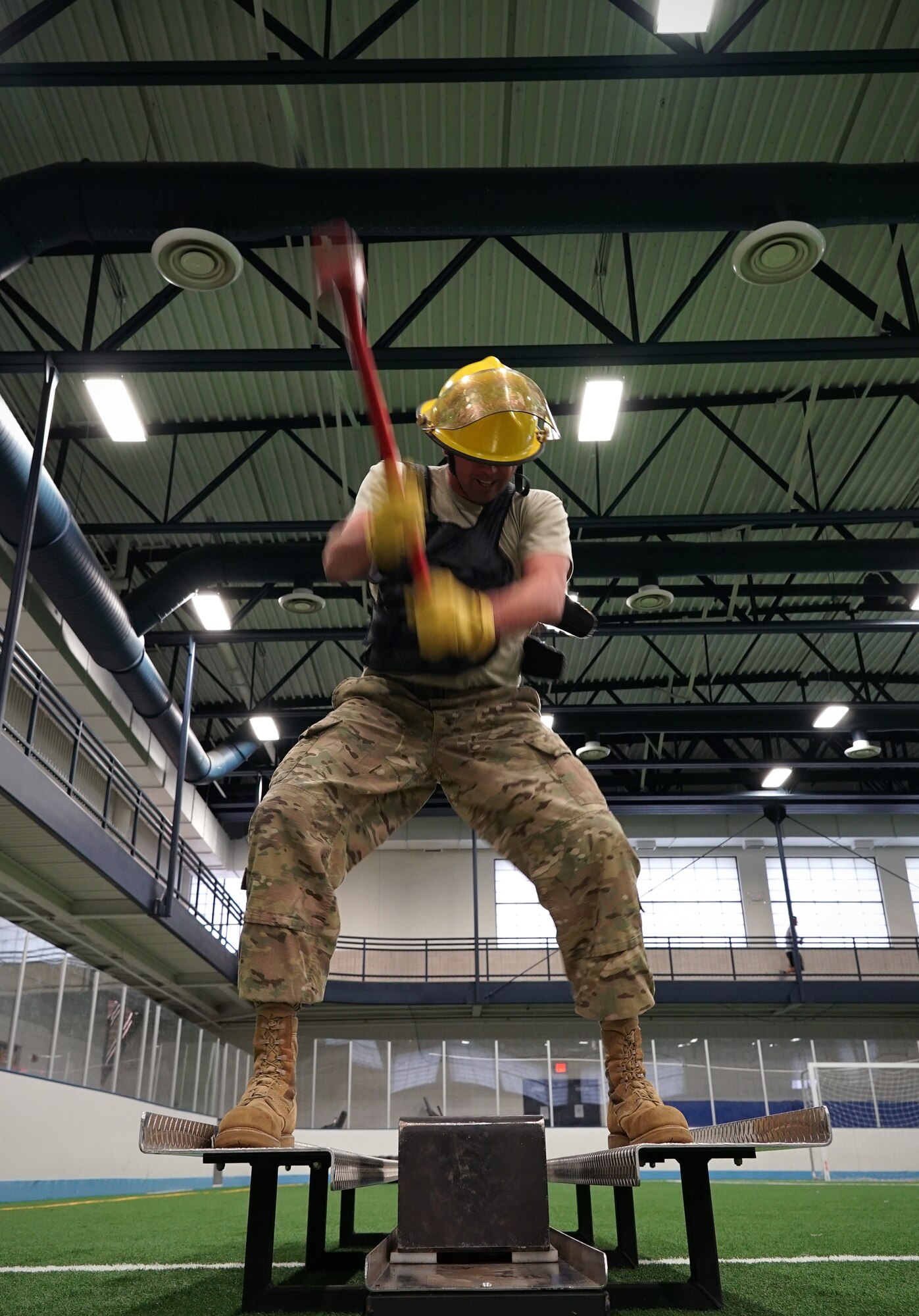 Master Sgt. Richard Mathews, 319th Logistics Readiness Squadron materiel management flight chief, uses a simulated forcible entry-chopping device during the base commander’s annual firefighter challenge Oct. 10, 2019, as part of National Fire Prevention Week on Grand Forks Air Force Base, North Dakota. Squadrons nominated teams of three to participate in the event, which featured six firefighting-themed strength challenges. (U.S. Air Force photo by Senior Airman Elora J. Martinez)