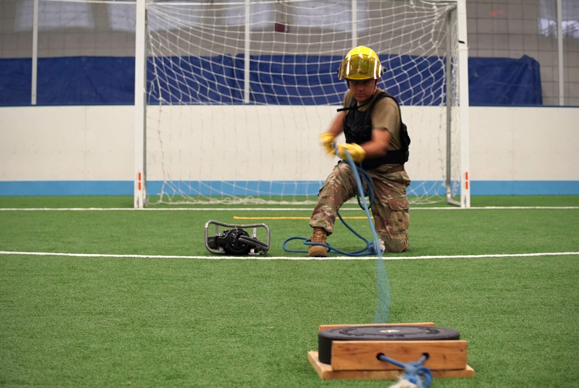 Maj. Tommy Rutherford, 319th Logistics Readiness Squadron commander, pulls a weighted plate towards himself as part of the base commander’s annual firefighter challenge Oct. 10, 2019, as part of National Fire Prevention Week on Grand Forks Air Force Base, North Dakota. Squadrons participated in the challenge with teams of three people, who completed a series of strength-challenging stations in attempt to complete the course with the fastest time. (U.S. Air Force photo by Senior Airman Elora J. Martinez)