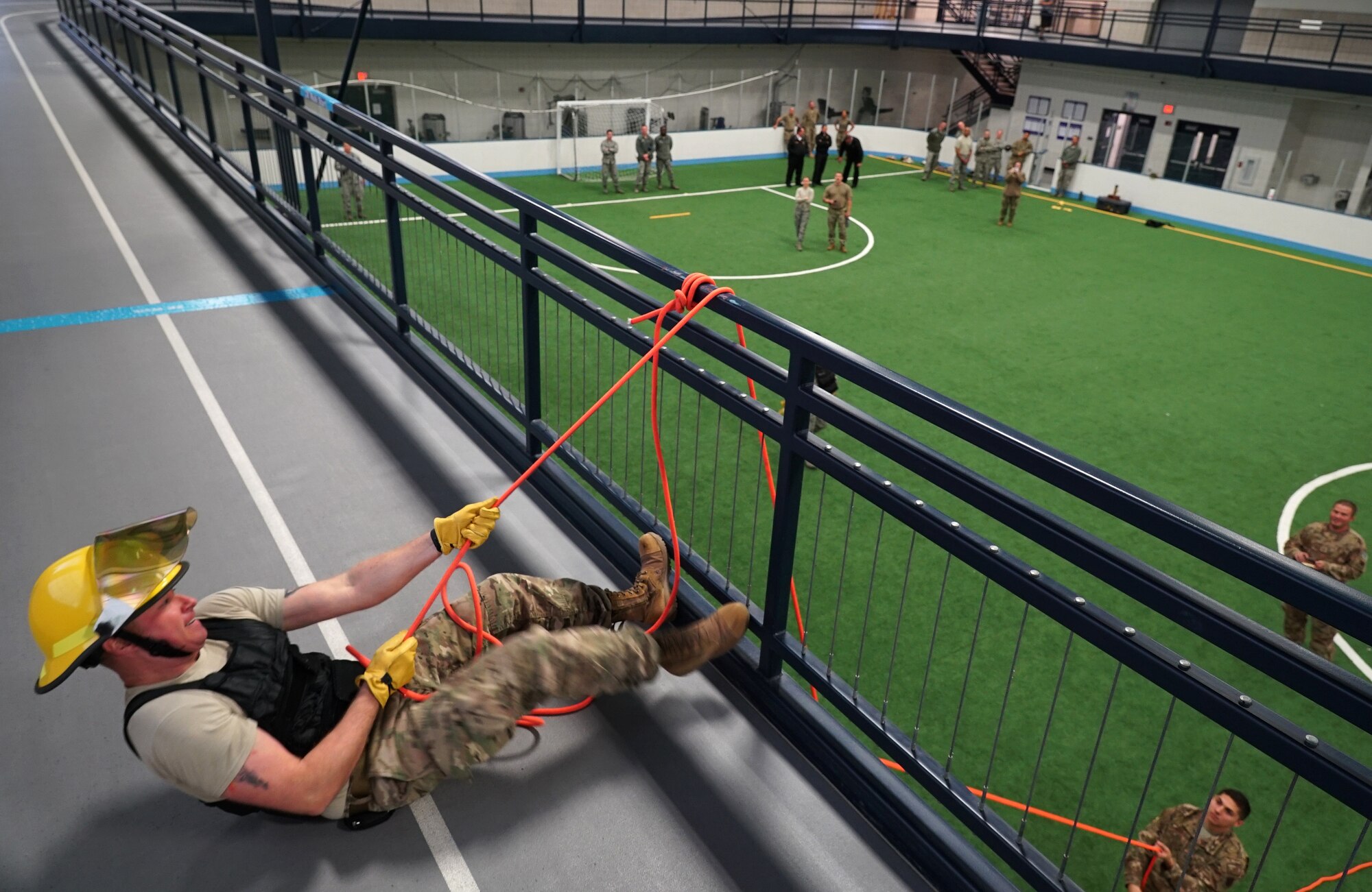 Maj. TJ Gabrielson, 319th Civil Engineer Squadron operations flight commander, pulls a weighted bag up to the second floor of the fieldhouse during the base commander’s annual firefighter challenge Oct. 10, 2019, as part of National Fire Prevention Week on Grand Forks Air Force Base, North Dakota. Gabrielson’s team competed against four others in a series of six firefighting-themed strength challenges, and took home the trophy with a winning time of less than two minutes. (U.S. Air Force photo by Senior Airman Elora J. Martinez)