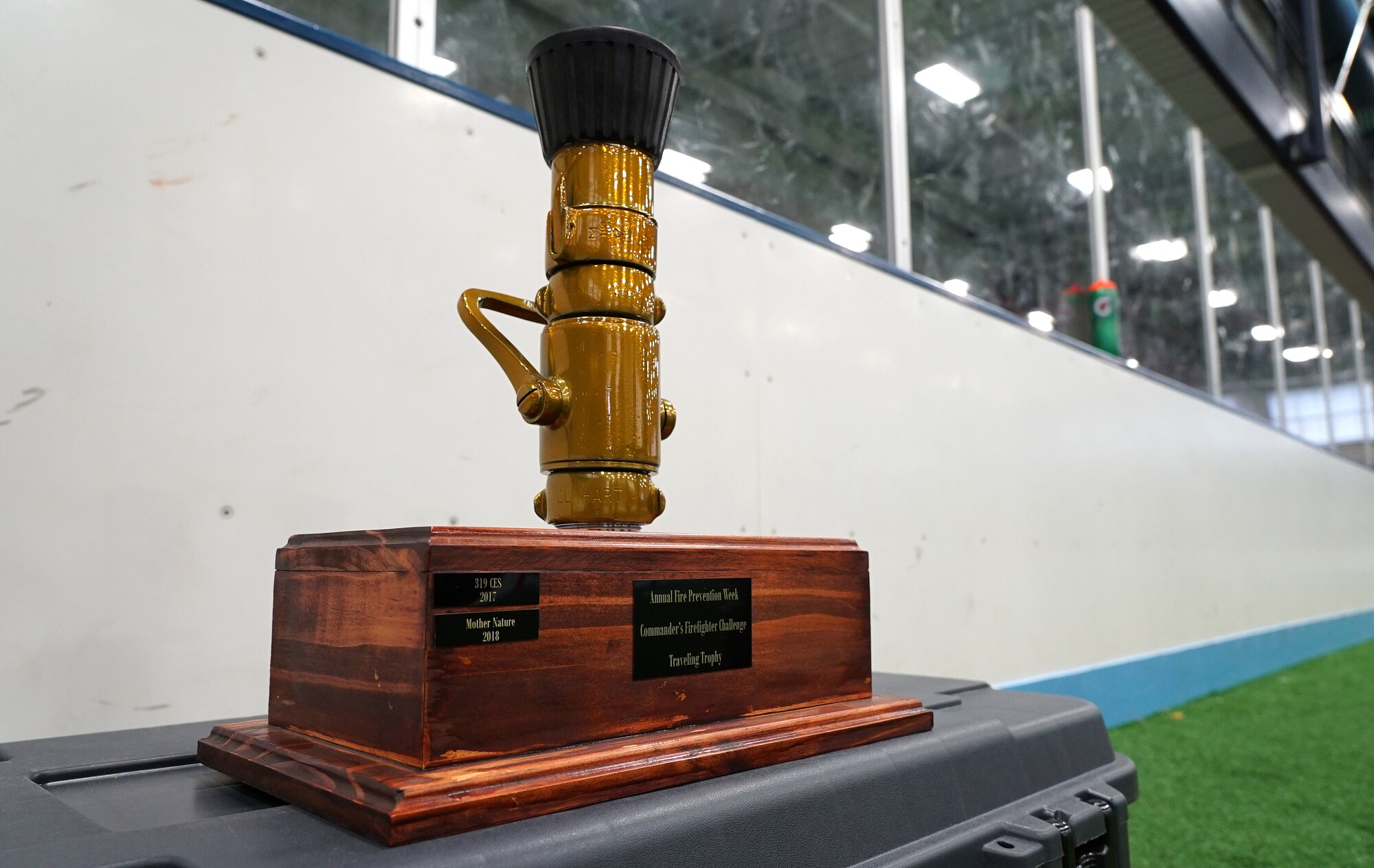 The trophy for the base commander’s annual firefighter challenge sits in the base gym Oct. 10, 2019, on Grand Forks Air Force Base, North Dakota. The challenge was part of National Fire Prevention Week, which was celebrated by the base community to bring more awareness to this year’s fire safety theme: “Not every hero wears a cape. Plan and practice your escape.” The 319th Civil Engineer Squadron’s three-man team won the trophy after completing six firefighting-themed strength challenges in less than two minutes. (U.S. Air Force photo by Senior Airman Elora J. Martinez)