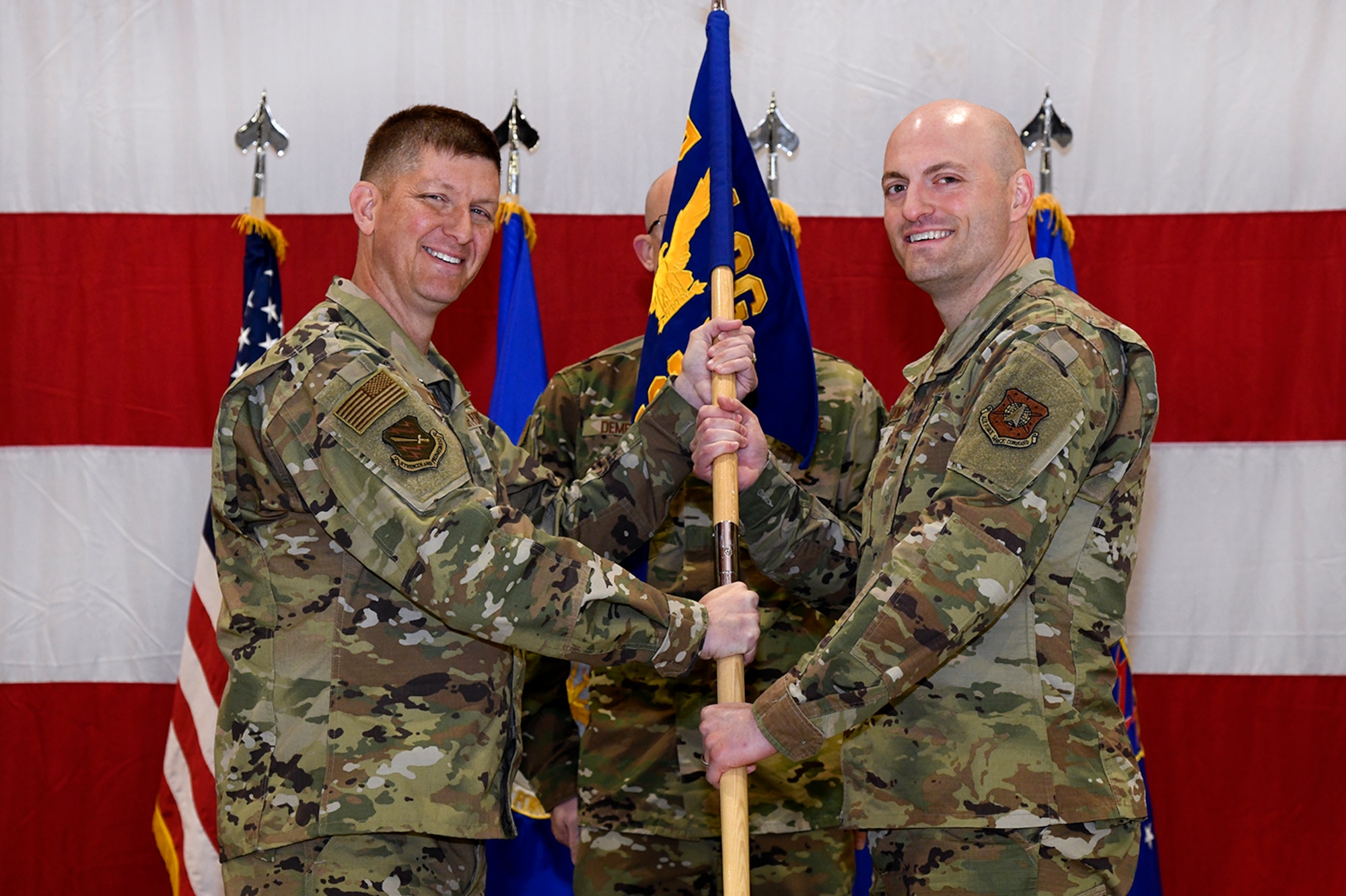 Col. John Thien, 721st Operations Group commander, passes the guidon to Lt. Col. Matthew Thompson, 721st Operations Support Squadron commander, during an activation ceremony Oct. 10, 2019 at Peterson Air Force Base, Colorado. The 721st Operations Support Squadron is comprised of five flights providing unrivaled and innovative operations support, including weapons system training, operational intelligence, weapons and tactics, and vault support to the 21st SW and deployed space electronic warfare units, while also deploying trained and ready Airmen. (U.S. Air Force photo by Craig Denton)