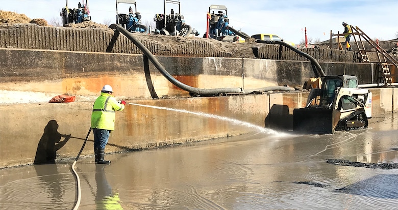 JOHN MARTIN RESERVOIR, Colo. – A worker with McMillen LLC cleans sediment from the stilling basin floor, Feb. 12, 2019. A $4.8 million contract for dewatering and sediment removal in the stilling basin area was awarded to McMillen LLC dba McMillen Jacobs Associates, Sept. 19, 2018.