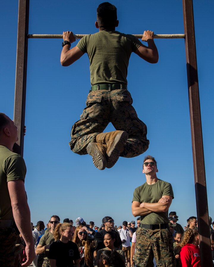 A Marine with Marine Aircraft Group (MAG) 39, 3rd Marine Aircraft Wing, conducts pull-ups for his team during the MAG-39’s Warrior Games on Marine Corps Base Camp Pendleton, Calif., Oct. 11, 2019. The MAG-39 Warrior Games is a morale building family event that allows the different units in MAG-39 to come together and create comradery amongst one another while also keeping true to their motto ‘Keep Winning’. (U.S. Marine Corps photo by Cpl. Levi J. Guerra)