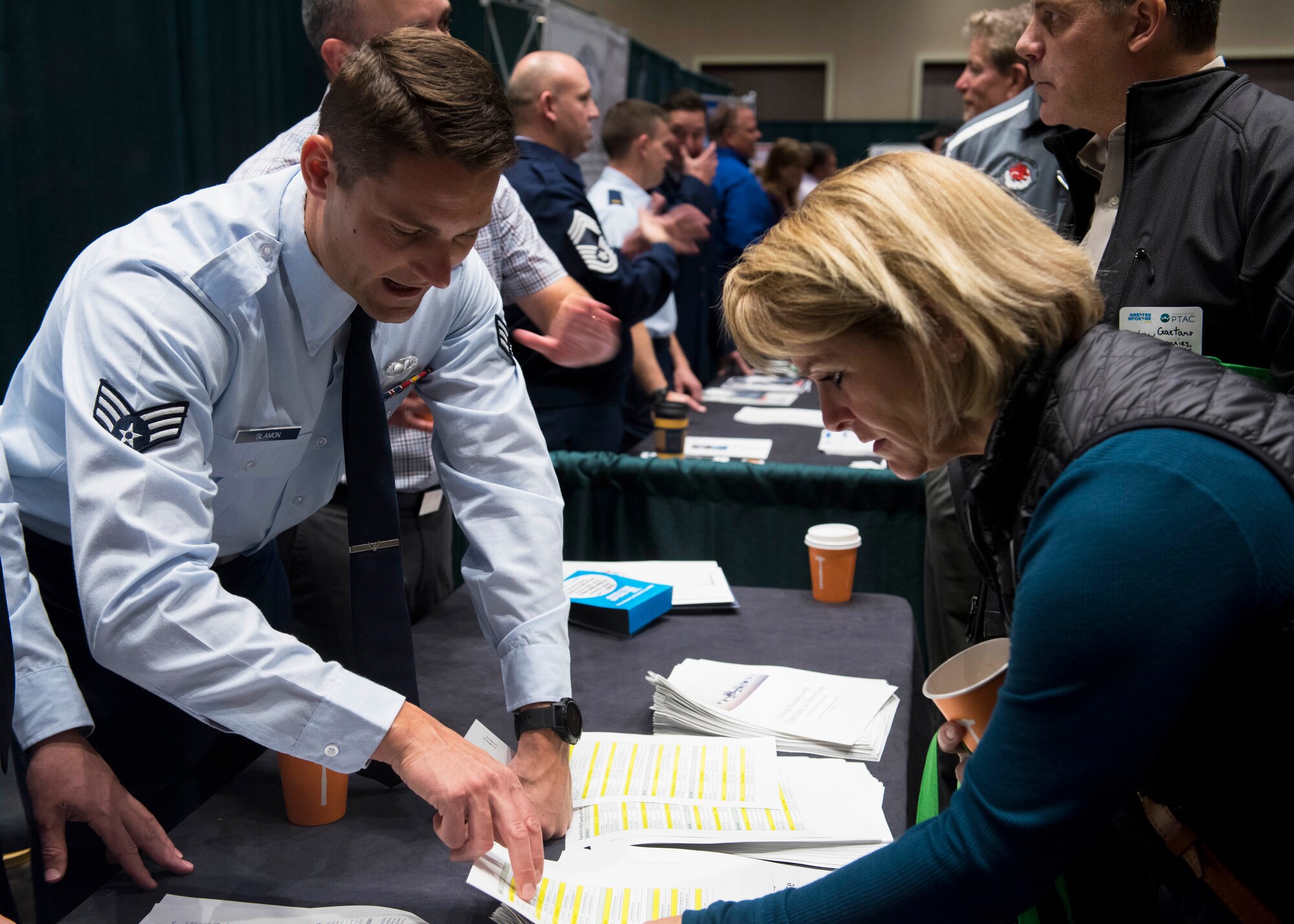 U.S. Air Force Senior Airman Zach Slamon, 92nd Contracting Squadron contracting specialist, speaks with a participant during the 2019 ‘Meet the Bigs’ hosted by Team Fairchild's 92nd CONS and Greater Spokane Incorporated at the Northern Quest Casino in Airway Heights, Washington, Oct. 15, 2019. This third-annual ‘Meet the Bigs’ event included participation from more than 50 large businesses and federal agencies. (U.S. Air Force photo by Airman 1st Class Lawrence Sena)