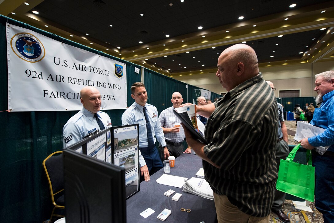 U.S. Air Force Senior Airmen Brian Fernandez (left) and Zachary Slamon (right), 92nd Contracting Squadron contracting specialists, host a booth representing Team Fairchild during the 2019 ‘Meet the Bigs’ event at the Northern Quest Casino in Airway Heights, Washington, Oct. 15, 2019. By partnering with Greater Spokane Incorporated to coordinate ‘Meet the Bigs,’ Team Fairchild continues to build and modernize its capabilities to ensure the delivery of strength and hope now and in the future. (U.S. Air Force photo by Airman 1st Class Lawrence Sena)