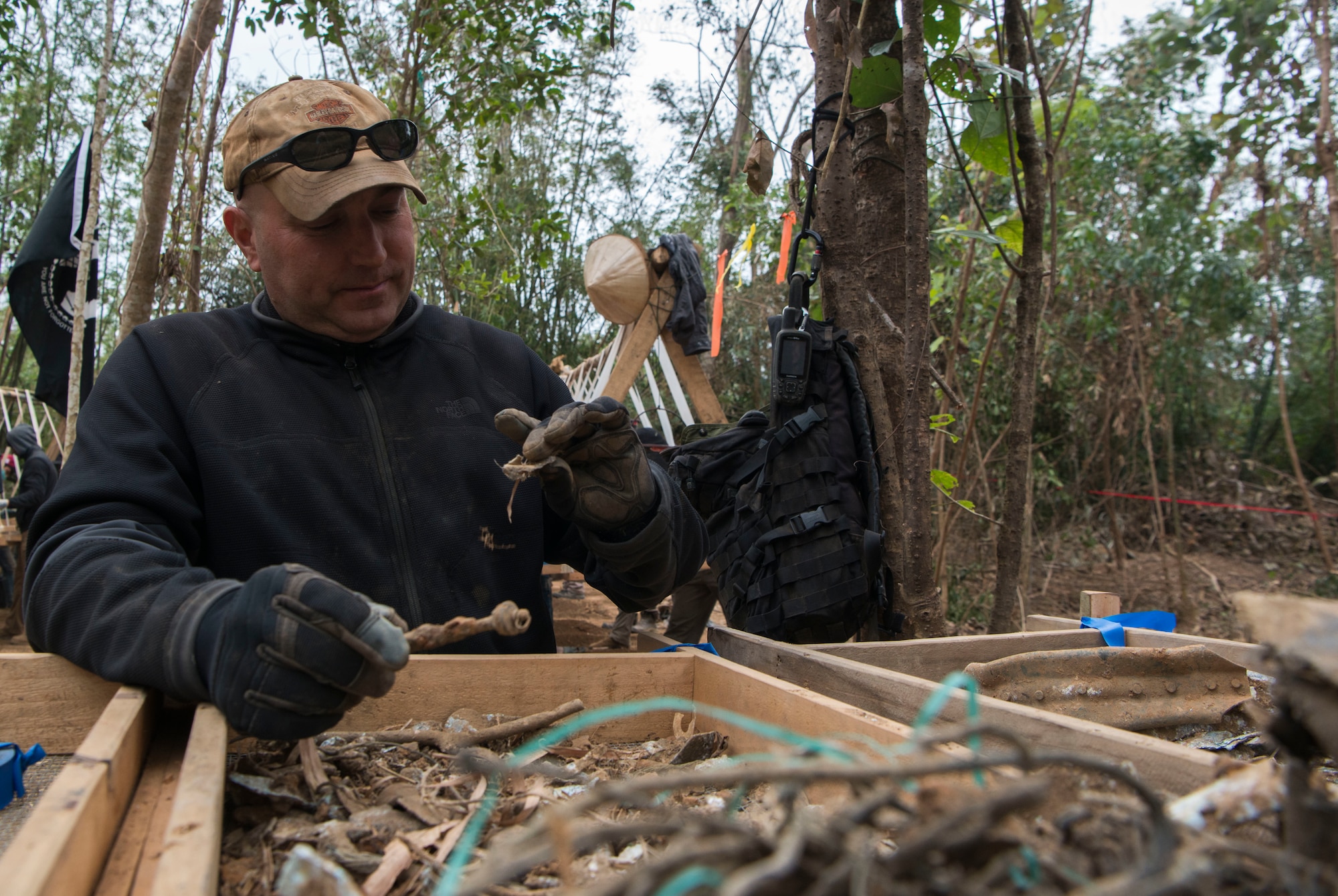 U.S. Air Force Senior Master Sgt. Jeremy Raymond, a life support investigator with the Defense POW/MIA Accounting Agency (DPAA), examines items in a screen during a DPAA recovery mission in Khammouan province, Lao People’s Democratic Republic, Feb. 4, 2018. DPAA team members deployed to the area in hopes of locating U.S. service members who went missing from the Vietnam War. The mission of DPAA is to provide the fullest possible accounting for our missing personnel to their families and the nation. (U.S. Air Force photo by Staff Sgt. Mikaley Kline)
