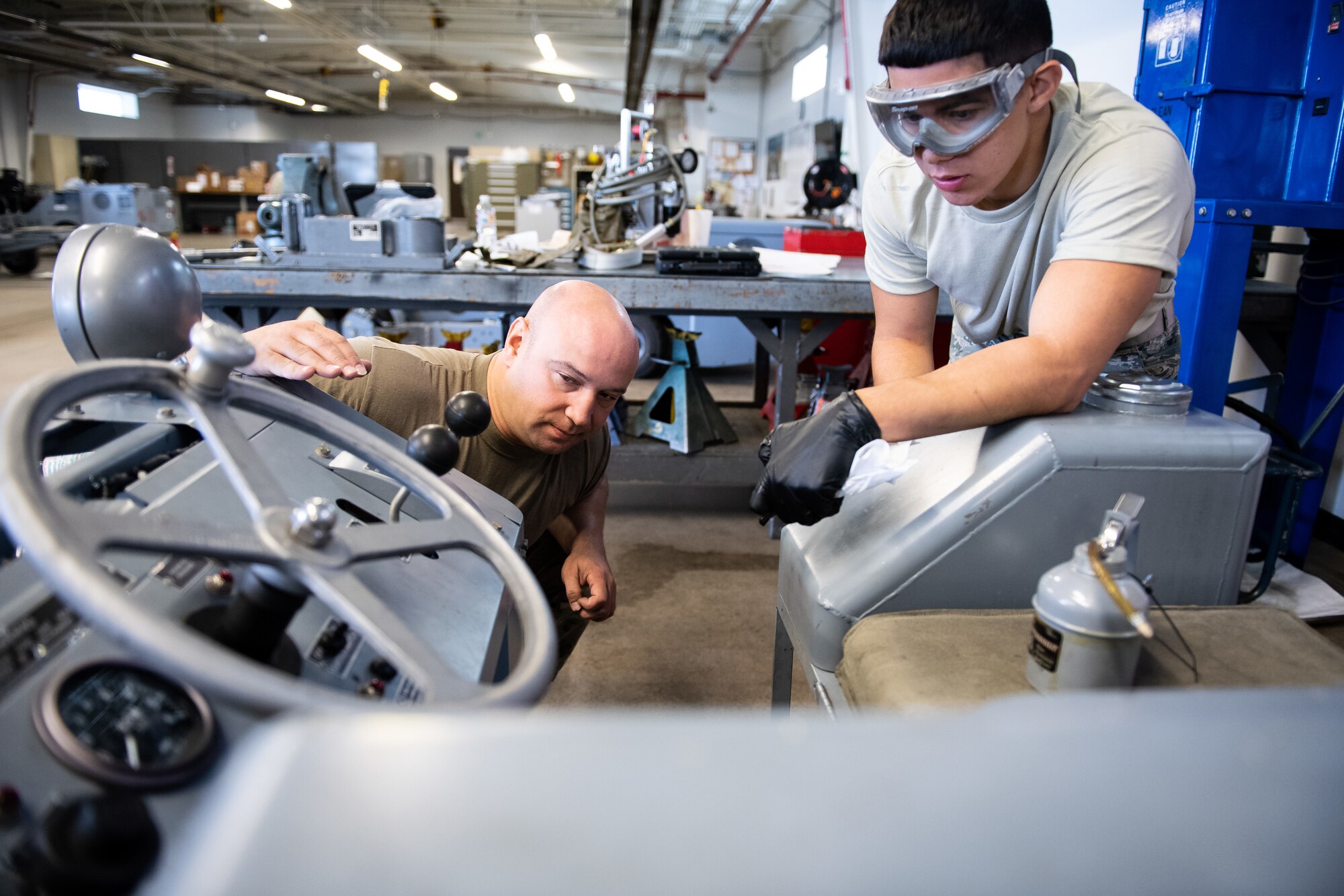Tech. Sgt. Boris Raykhel, left, and Airman 1st Class Javier Saldana, 388th Aerospace Ground Equipment Flight, inspect a munitions loader during maintenance at Hill Air Force Base, Utah, Oct. 4, 2019. Unit Airmen maintain over 600 pieces of equipment that support the mission of crew chiefs, avionics, weapons and ammo troops. (U.S. Air Force photo by R. Nial Bradshaw)