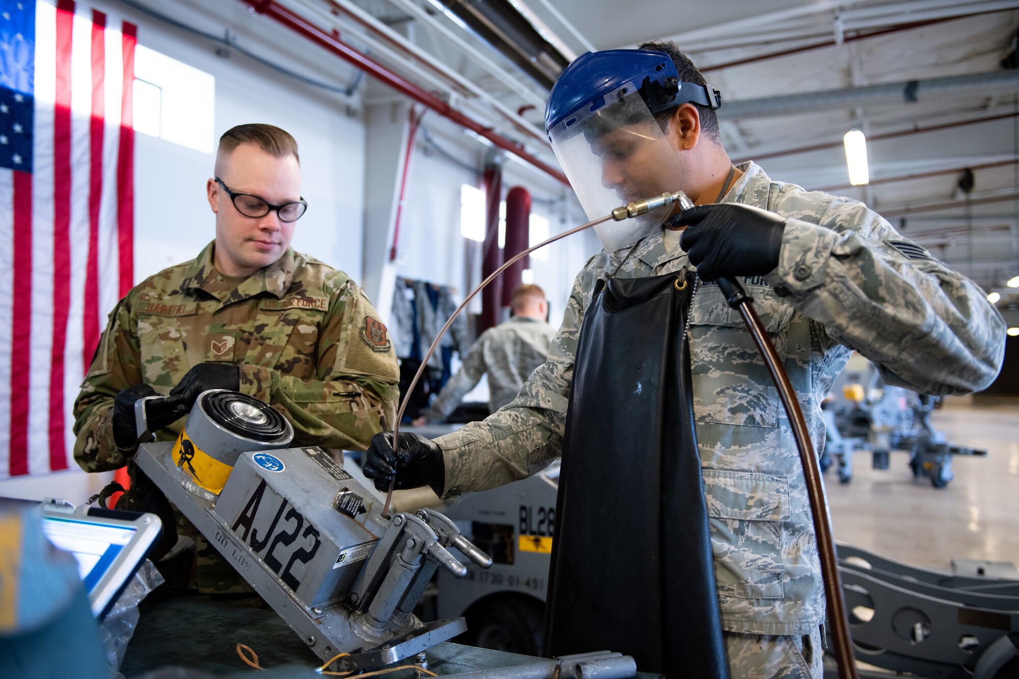 Staff Sgt. Emmanuel May, right, and Staff Sgt Keith Hartfiel, 419th Maintenance Squadron Aerospace Ground Equipment Flight, remove fluid from a piece of equipment during maintenance at Hill Air Force Base, Utah, Oct. 4, 2019. Unit Airmen maintain over 600 pieces of equipment that support the mission of crew chiefs, avionics, weapons and ammo troops. (U.S. Air Force photo by R. Nial Bradshaw)