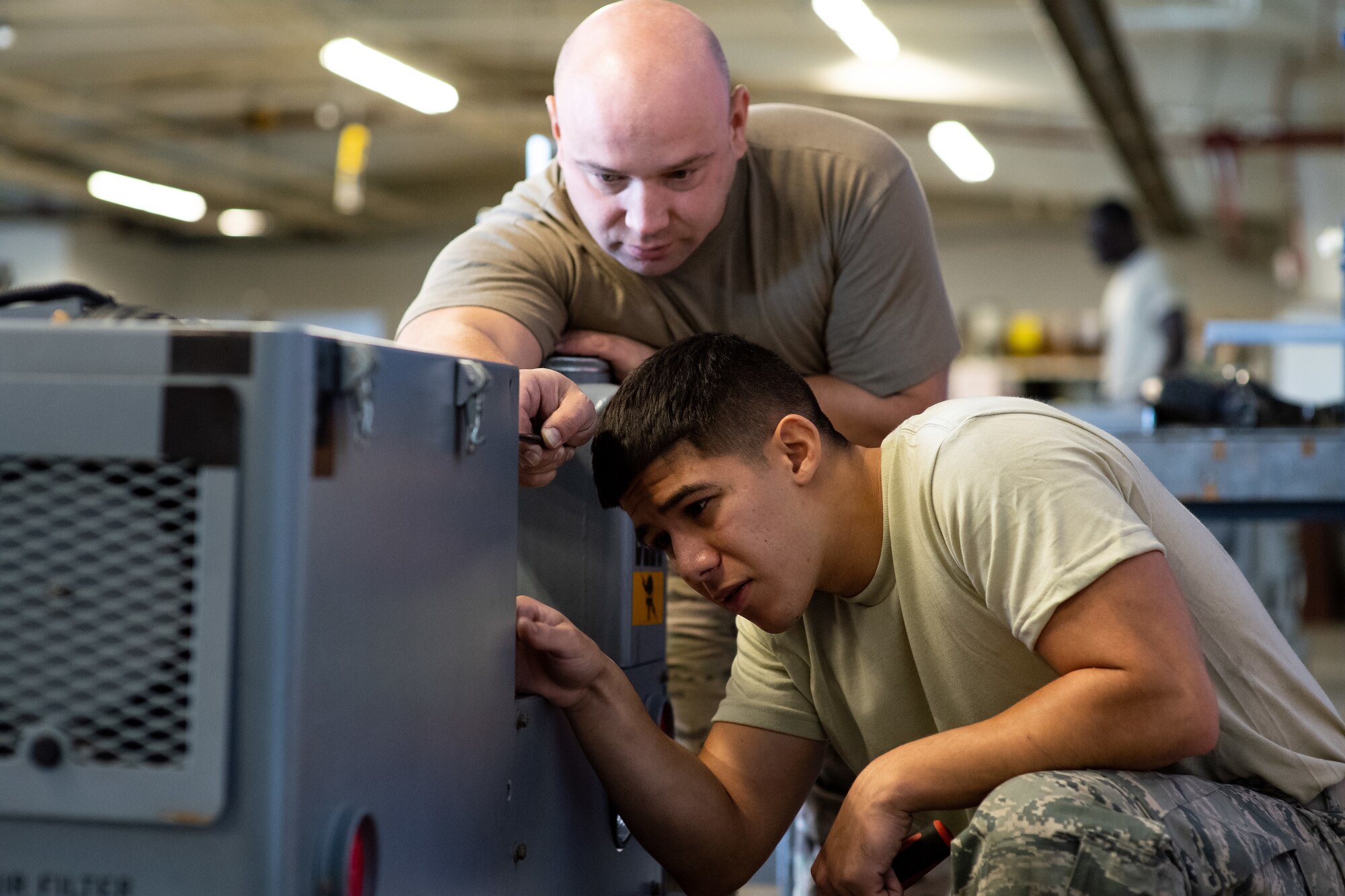 Tech. Sgt. Boris Raykhel, left, and Airman 1st Class Javier Saldana, 388th Aerospace Ground Equipment Flight, work on a munitions loader during maintenance at Hill Air Force Base, Utah, Oct. 4, 2019. Unit Airmen maintain over 600 pieces of equipment that support the mission of crew chiefs, avionics, weapons and ammo troops. (U.S. Air Force photo by R. Nial Bradshaw)
