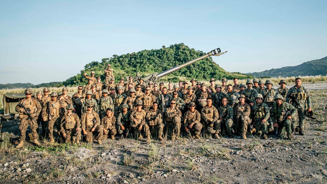 U.S. Marines and Philippine Marines with the 17th Marine Corps Field Artillery Battalion, pose for a group photo