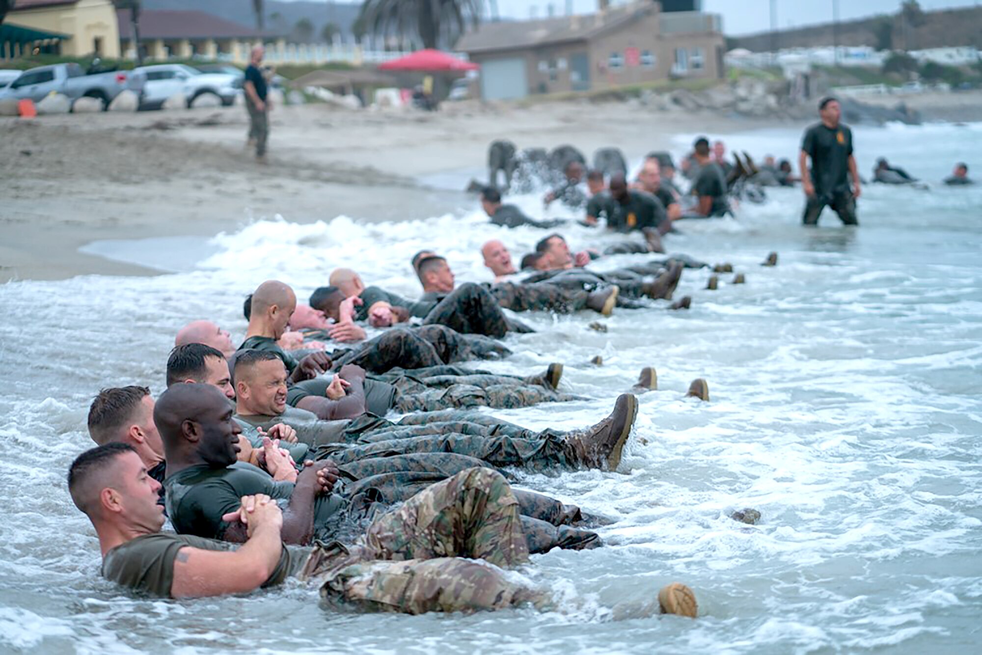 Master Sgt. Paul Willson (left) leads his group in physical training on the San Onofre Beach during the Marine Corps Staff NCO Academy at Camp Pendleton, California.