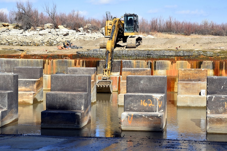JOHN MARTIN RESERVOIR, Colo. – The baffle blocks in the reservoir’s stilling basin are seen in this photo taken March 25, 2019. In the background, the contractor uses an excavator to remove equipment from the stilling basin.
