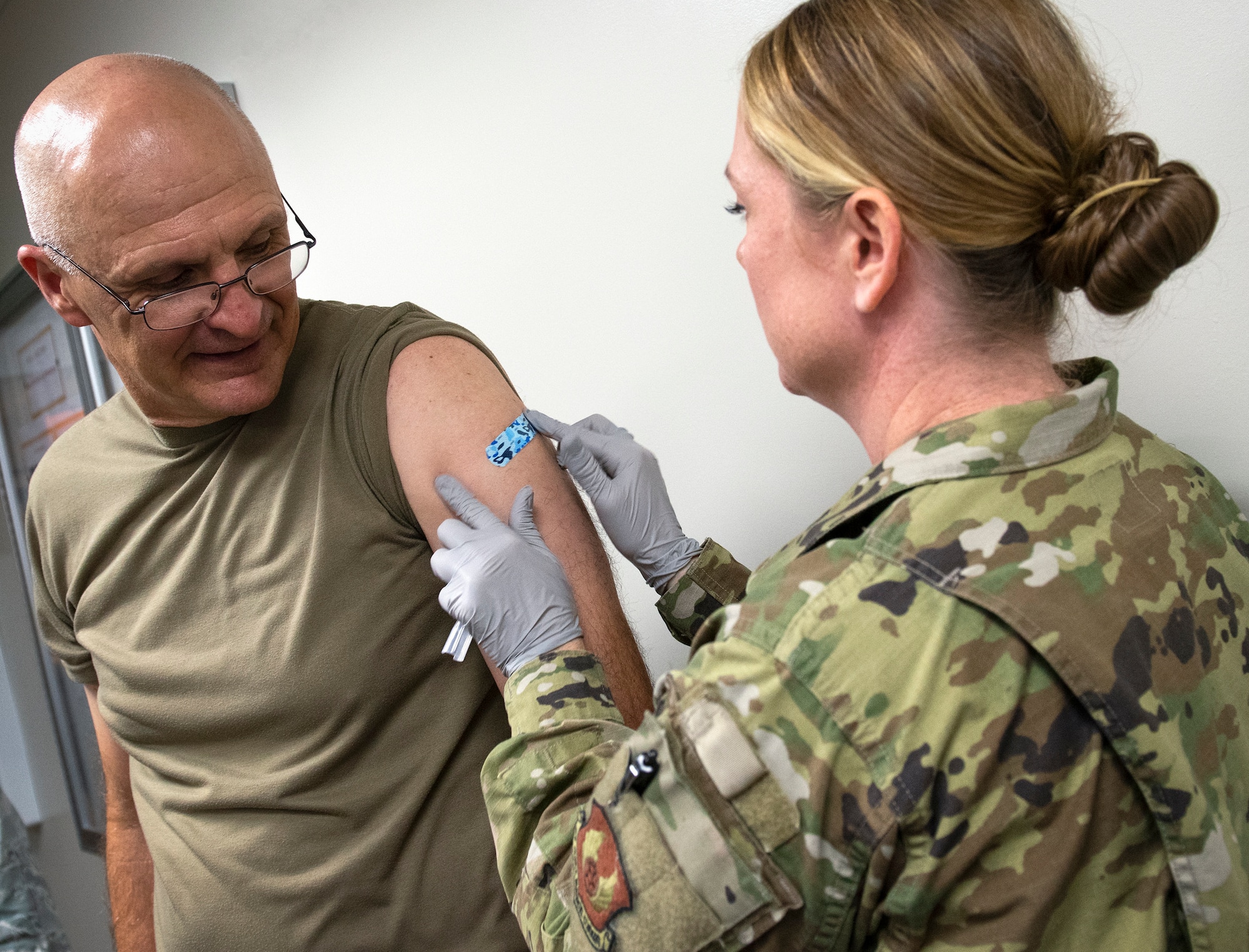 U.S. Air Force Gen. Arnold Bunch, Air Force Materiel Command commander, gets a bandage from Tech. Sgt. Amanda Grant after receiving his flu shot at Eglin Air Force Base, Florida, Oct. 16, 2019. The flu shot came during the Bunch’s tour of the 96th Medical Group facilities, one of many stops during his two-day tour of the base. (U.S. Air Force photo by Ilka Cole)