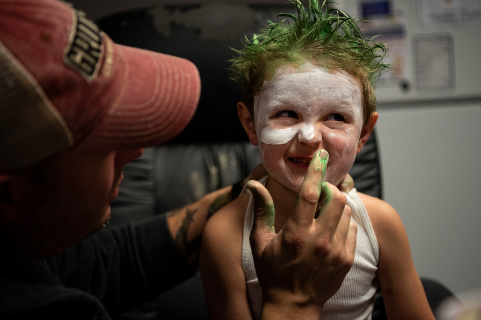 U.S. Air Force Master Sgt. Austin May, 52nd Fighter Wing Public Affairs community engagement section chief, left, applies face paint to Jacob Goldfuss, 3, son of May and Staff Sgt. Candace Goldfuss, 52nd Security Forces Squadron Operations NCO, at Spangdahlem Air Base, Germany, Oct. 17, 2019. May and Jacob trick-or-treated at this month's Airman and Family Readiness Center deployed-family event. (U.S. Air Force photo by Airman 1st Class Valerie Seelye)