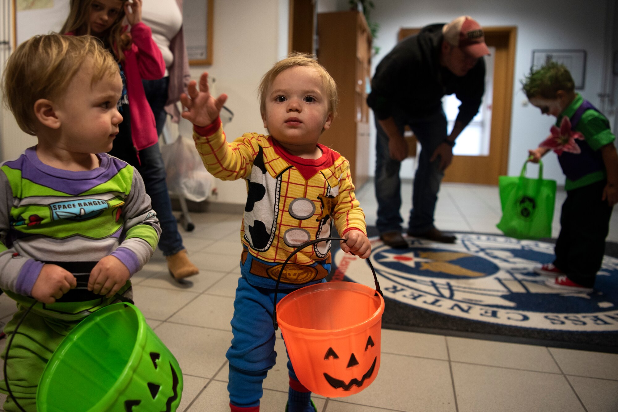 Spangdahlem Air Base families prepare to trick-or-treat in the Airman and Family Readiness Center during a deployed-family event at Spangdahlem AB, Germany, Oct. 17, 2019. The center hosts monthly events to support families affected by deployments or short tours. (U.S. Air Force photo by Airman 1st Class Valerie Seelye)