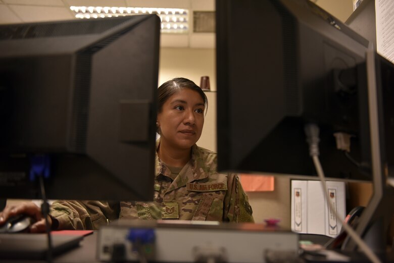 Tech. Sgt. Alejandra Martinez, 379th Air Expeditionary Wing security manager and executive administration non-commissioned officer-in-charge, reviews policies and procedures at her workstation at Al Udeid Air Base, Qatar on Oct. 18, 2019.