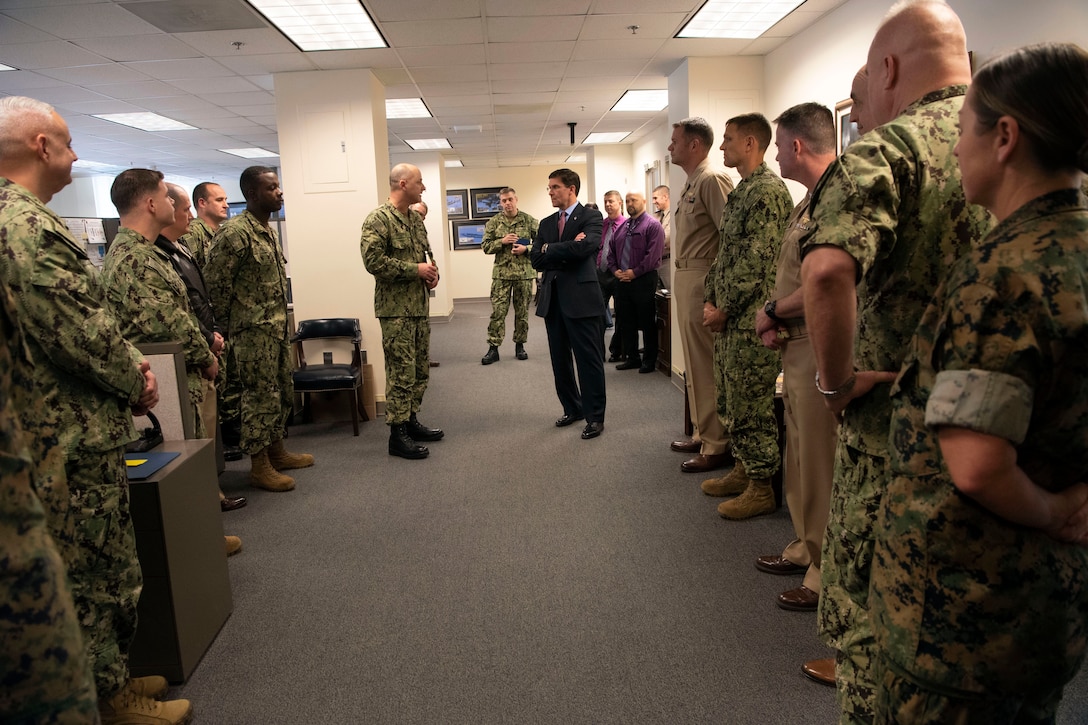 Defense Secretary Dr. Mark T. Esper speaks to service members in a room at the Pentagon.