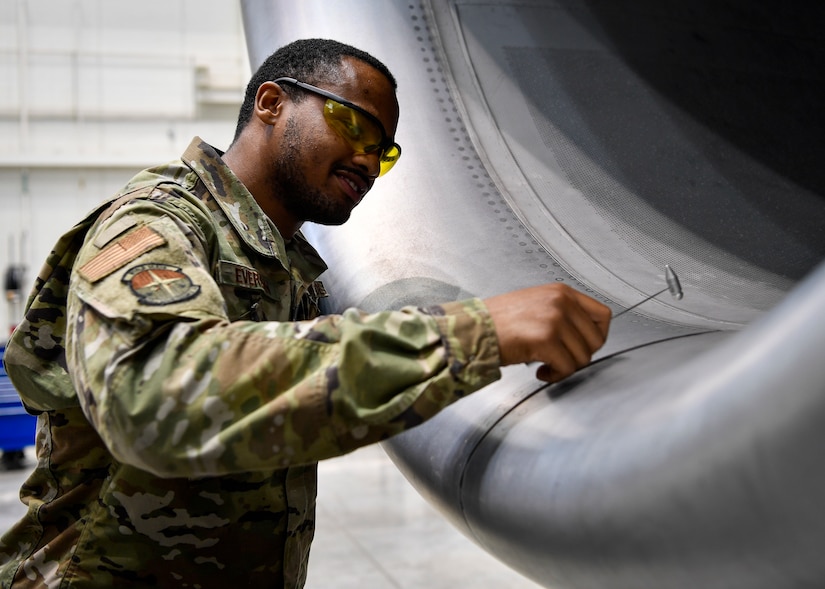 U.S. Air Force Senior Airman Armani Everson, 305th Maintenance Squadron Fabrication Flight aircraft structural maintenance journeymen, taps on an aircraft engine to see if any deficiencies are present on Joint Base McGuire-Dix-Lakehurst, New Jersey, Oct. 16, 2019. Aircraft structural maintenance Airmen assess damage to aircraft and structural components and repair or replace necessary parts. The mission of the 305th MXS is to enhance global response by providing world class systems, support equipment, munitions and aircraft maintenance. (U.S. Air Force photo by Senior Airman Jake Carter)
