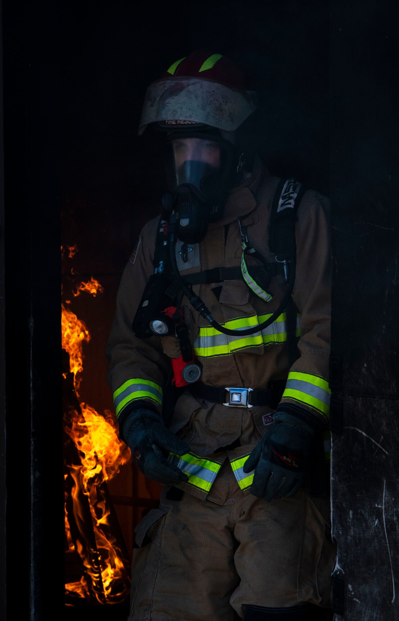 Firefighter stands in doorway