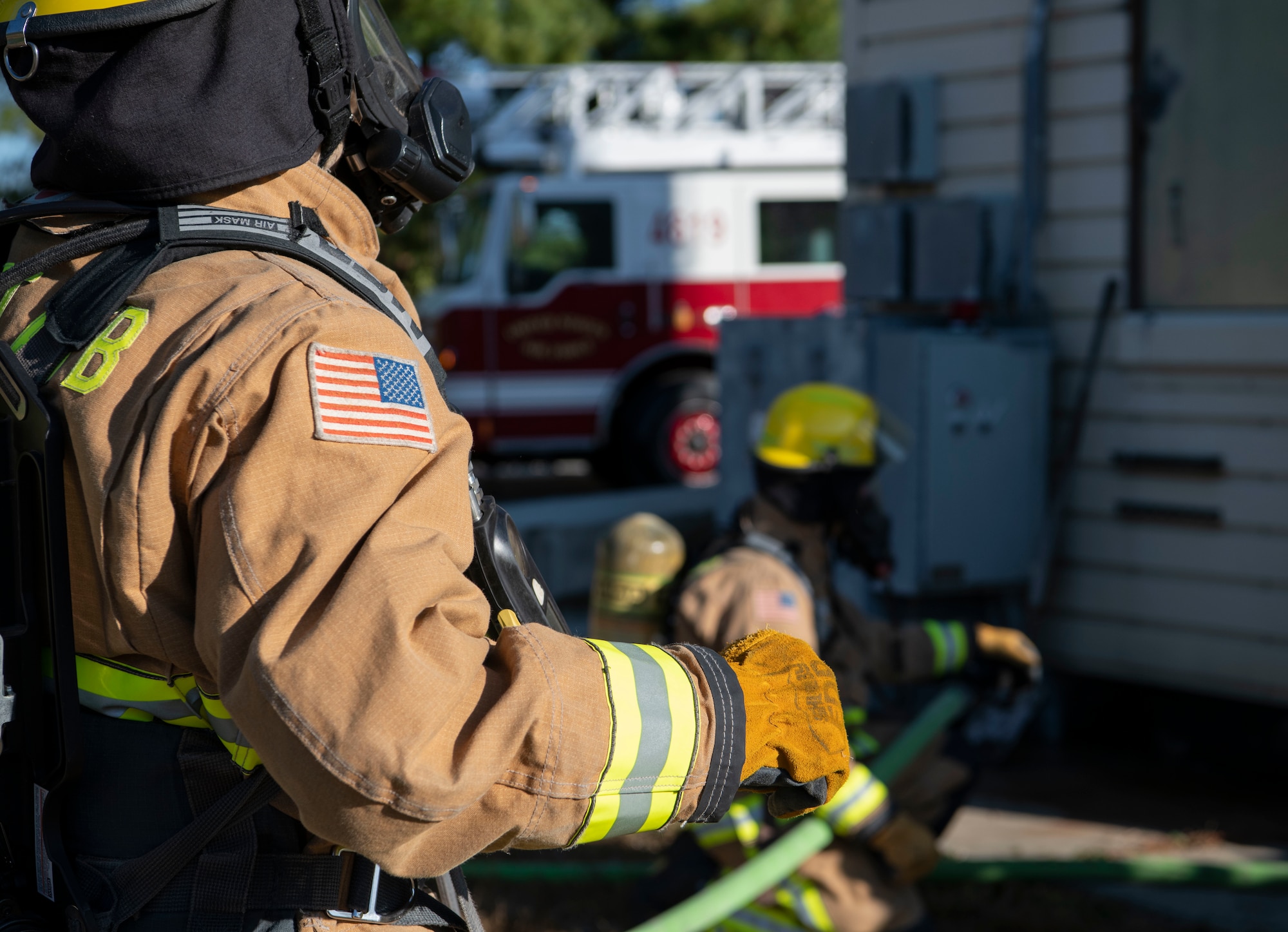 Firefighter holds hose