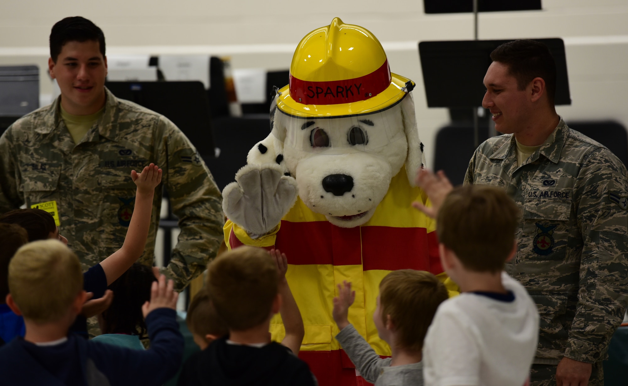 Kids high-five Sparky the dog