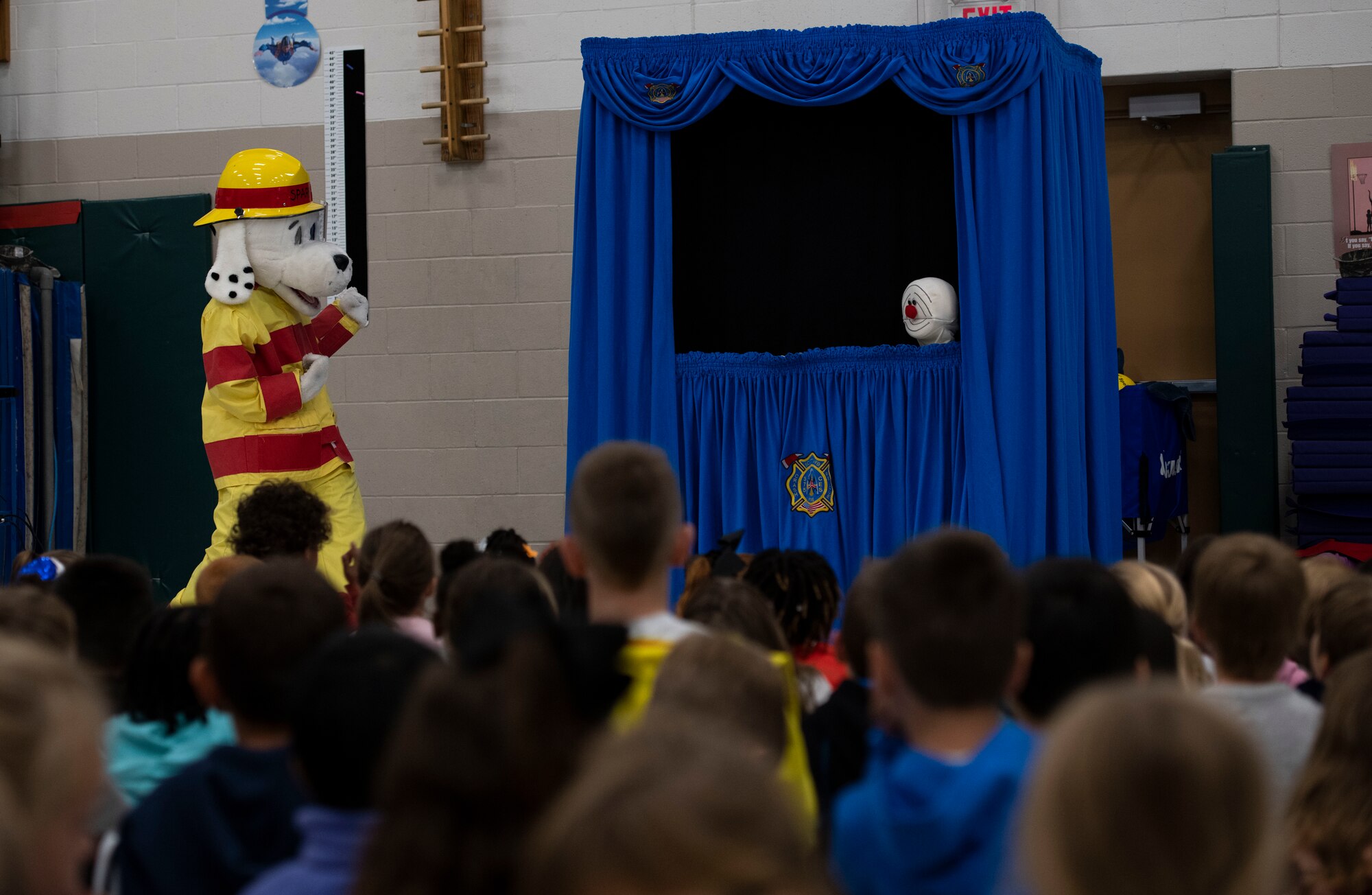 Kids watch a puppet show.