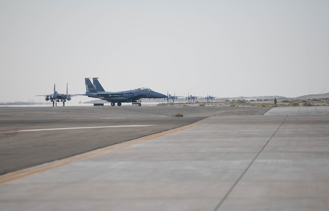 U.S. Air Force F-15E Strike Eagles from the 494th Fighter Squadron taxi to park at Al Dhafra Air Base, United Arab Emirates, Oct. 18, 2019.