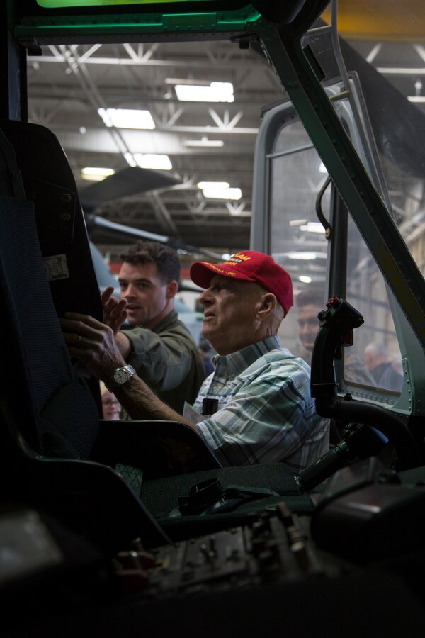 U.S. Marine Corps Capt. Joseph Deignan, adjutant for Marine Light Attack Helicopter Squadron 303, Marine Aircraft Group 39, 3rd Marine Aircraft Wing, discusses the new upgrades to the UH-1Y Venom with retired Marine Corps Capt. Steve Sipes during the Marine Observation Squadron (VMO) 6 reunion on Marine Corps Air Station Camp Pendleton, Calif., Oct. 16, 2019. The VMO-6 reunion gave the veterans an opportunity to see their old stomping grounds and admire how far the aircraft that their generation paved the way for have come. (U.S. Marine Corps photo by Cpl. Levi J. Guerra)