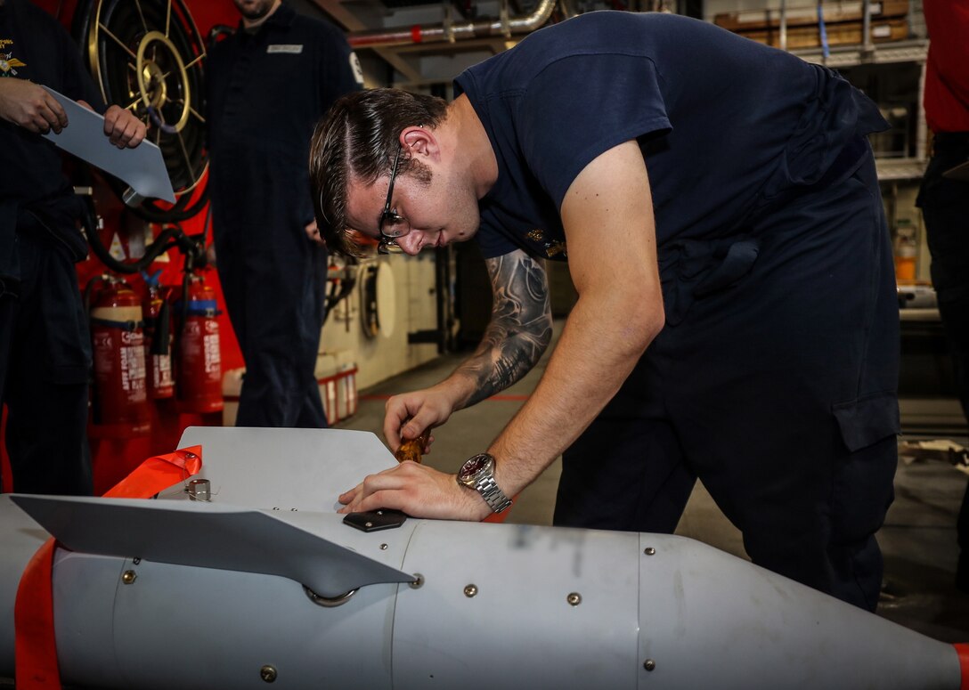 HMS Queen Elizabeths Air Weapons Party member AET Joshua Elwen fits a fin to one of the Paveway II bombs. The first bombs to be dropped from F-35B Lightning II fighter jets conducting trials onboard HMS Queen Elizabeth of the U.S. eastern seaboard occurred Oct. 9, 2018, with inert GBU-12 Paveway II laser guided precision bombs, marking another significant milestone in the carrier’s trials.

Royal Navy photo
