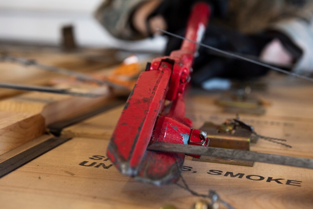Senior Airman Austin Decious, 23d Maintenance Squadron conventional maintenance technician, cuts straps on a munitions delivery Oct. 17, 2019, at Moody Air Force Base, Ga. The Munitions Flight Production Division is responsible for maintaining, inspecting, producing and delivering ammo to Moody’s munitions holding area. Following technical orders for operations and procedures allow the Airmen to minimize errors in their stock of over 52 million munitions, ensuring the fighter squadrons are prepared for future operations. (U.S. Air Force photo by Airman Elijah M. Dority)