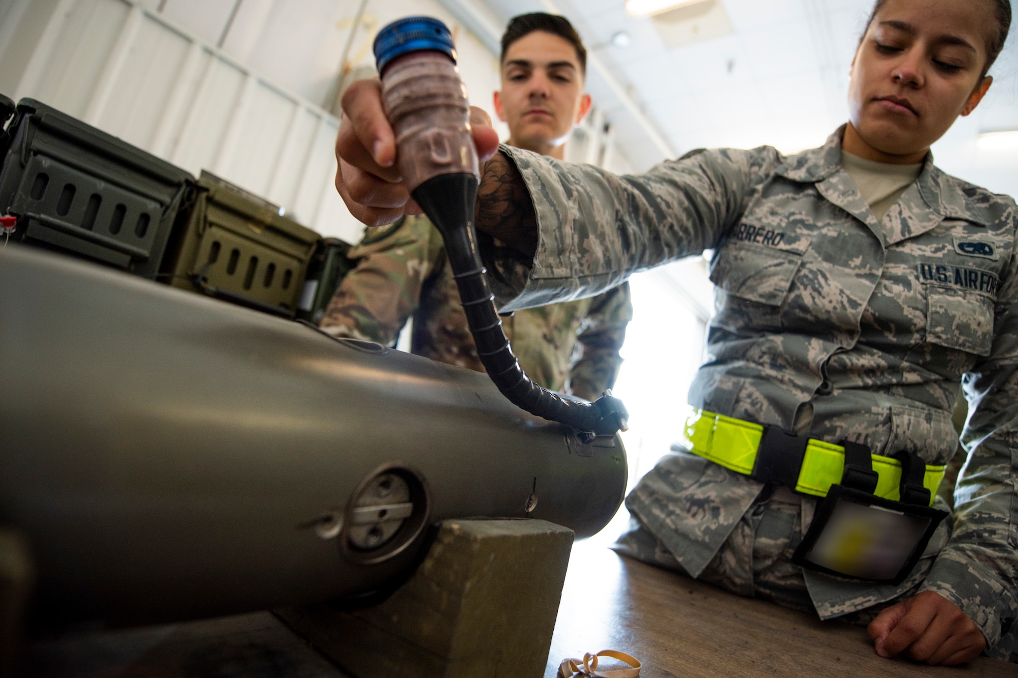 Senior Airman Alysia Carrero, right, 23d Maintenance Squadron munitions systems specialist crew chief, inspects a munition Oct. 17, 2019, at Moody Air Force Base, Ga. The Munitions Flight Production Division is responsible for maintaining, inspecting, producing and delivering ammo to Moody’s munitions holding area. Following technical orders for operations and procedures allow the Airmen to minimize errors in their stock of over 52 million munitions, ensuring the fighter squadrons are prepared for future operations. (U.S. Air Force photo by Airman Elijah M. Dority)