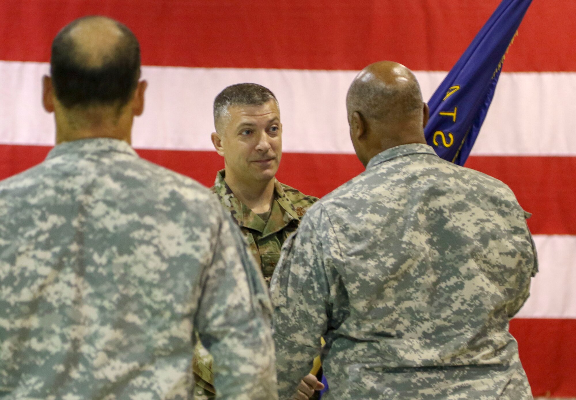Brig. Gen. Torrence Saxe, the adjutant general of the Alaska National Guard, passes the Alaska State Defense Force's unit colors to the incoming commander, Col. Simon Brown, at a change of command ceremony on Joint Base Elmendorf-Richardson, Oct. 16, 2019. The previous commander, Col. John James, has served in the ASDF since 2011.