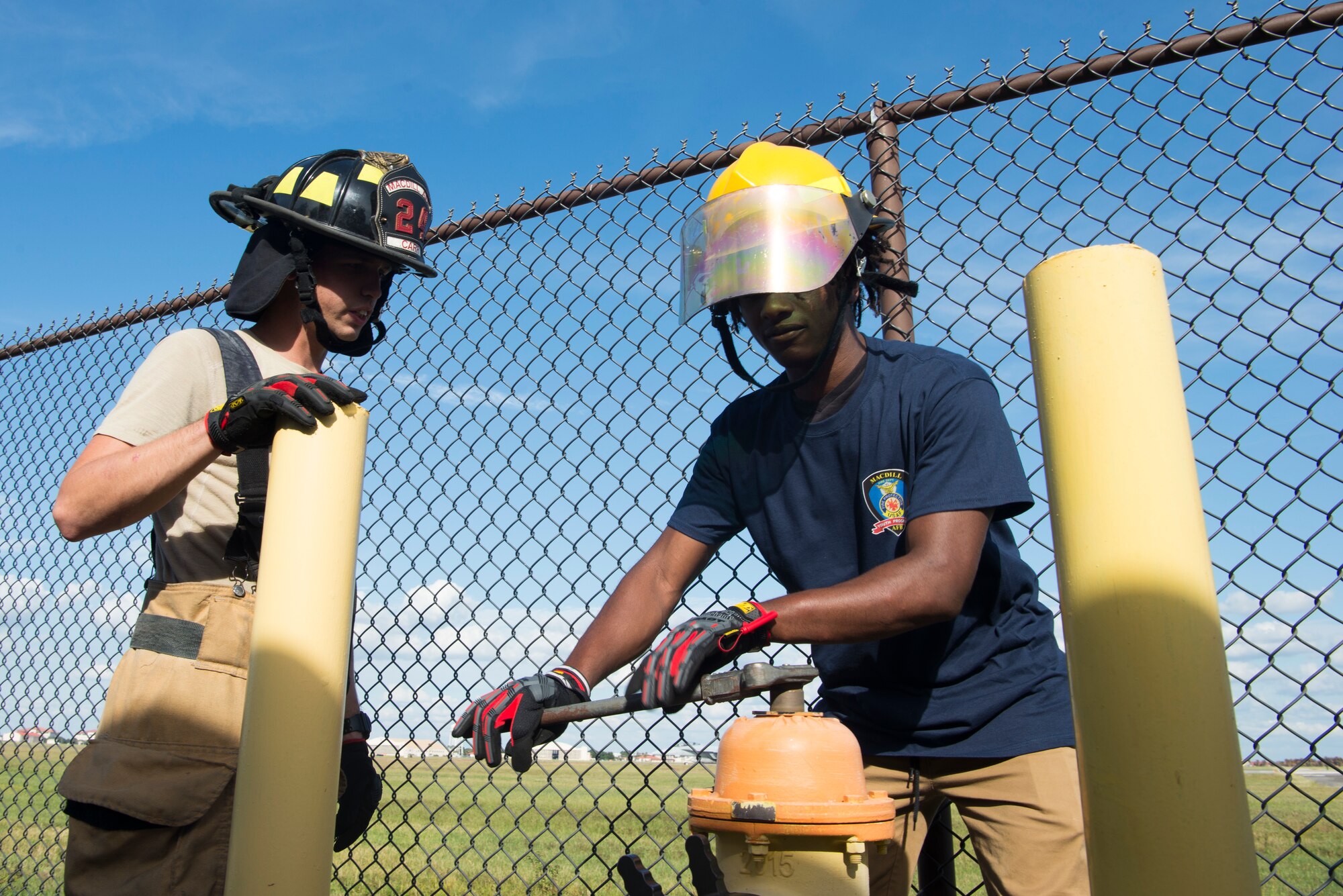 Senior Airman Kenneth Carr, a 6th Civil Engineer Squadron (CES) Fire Emergency Services (FES) Flight firefighter, teaches a student how to access a fire hydrant at MacDill Air Force Base, Fla., Oct. 15, 2019.