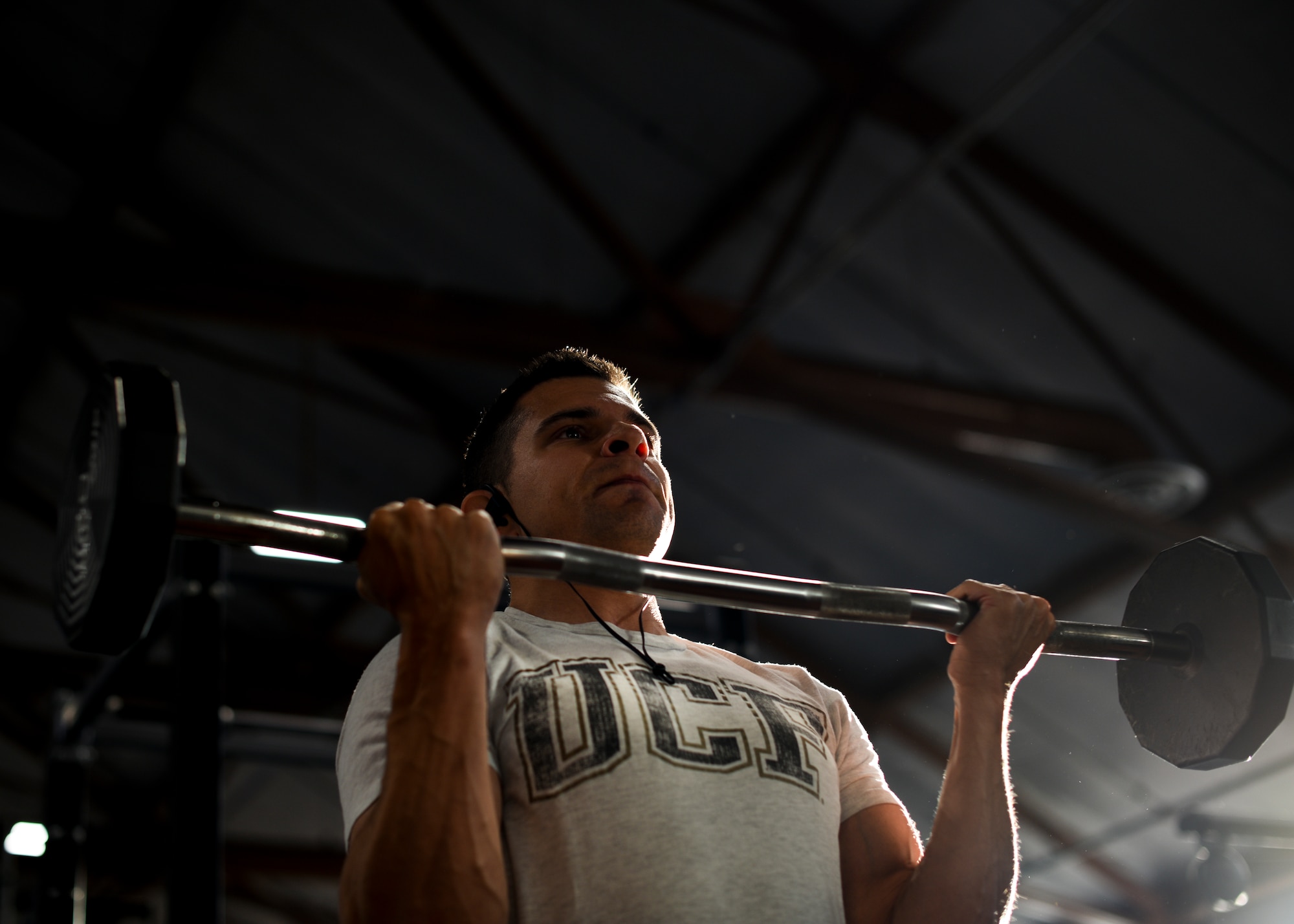 Major Richard Bottinelli, 90th Force Support Squadron operations officer, curls a barbell at the Independence Hall Fitness Center on F.E. Warren Air Force Base, Wyo., July 18, 2019. Along with a strict gym regiment, Bottinelli had to stick to a diet plan throughout his training.  (U.S. Air Force photo by Staff Sgt. Ashley N. Sokolov)